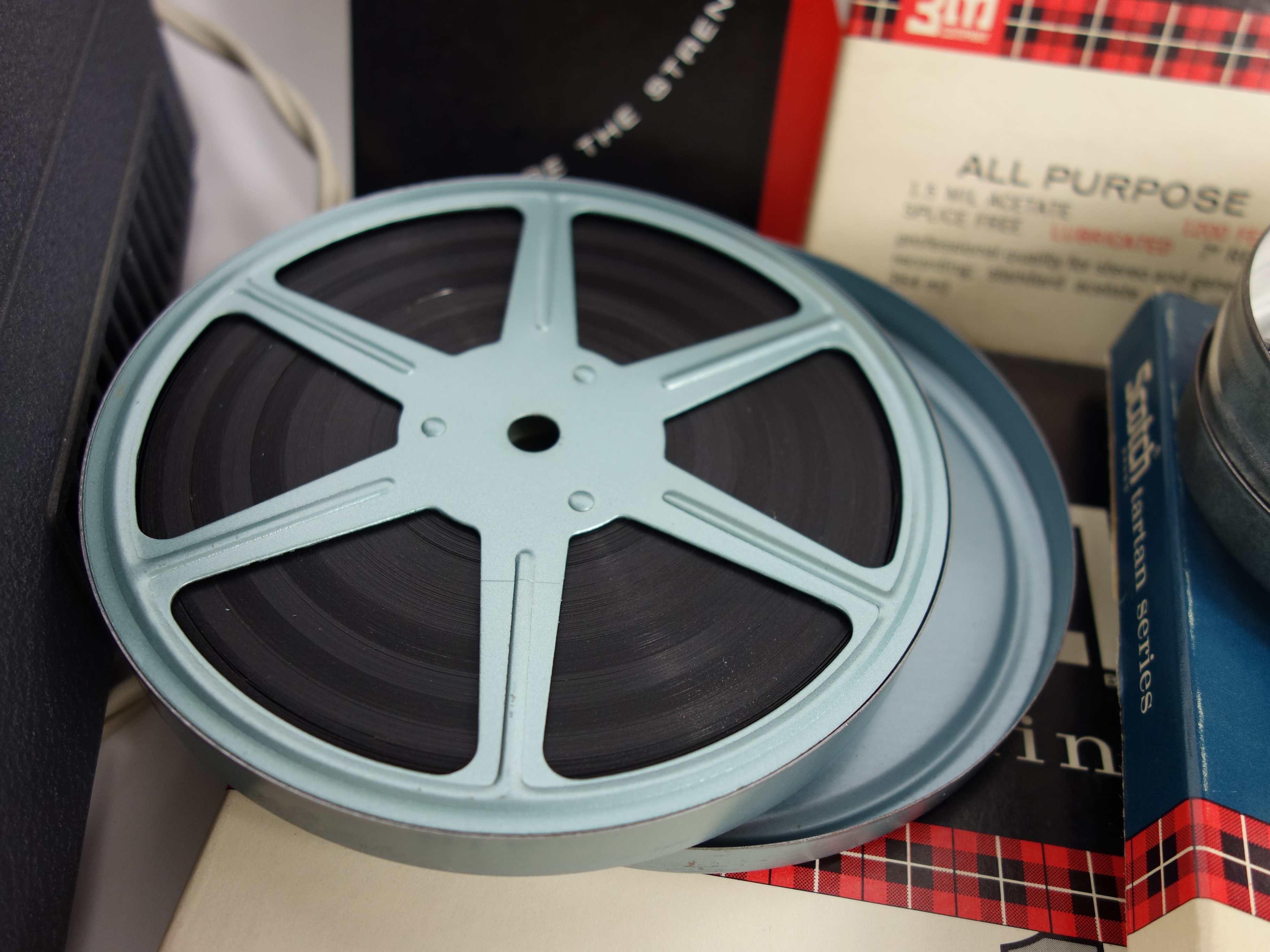 Projector and Vintage Tape Reels With News, Other Recordings