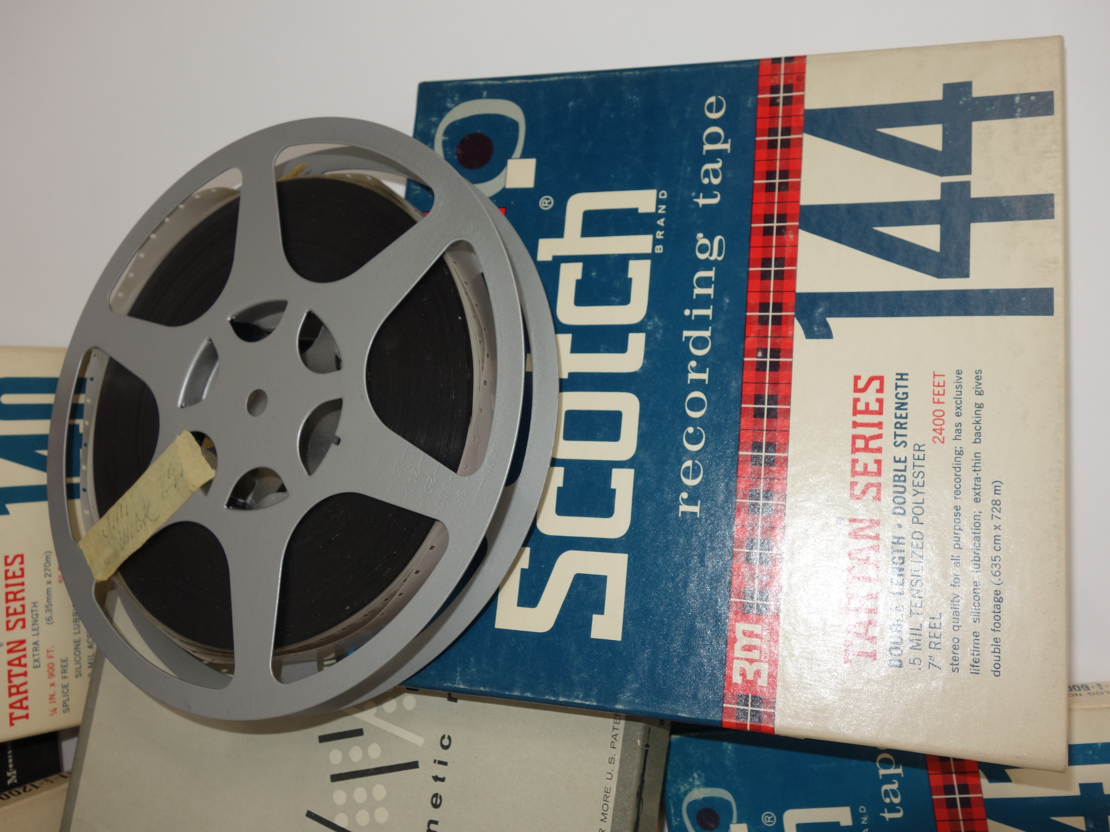Projector and Vintage Tape Reels With News, Other Recordings