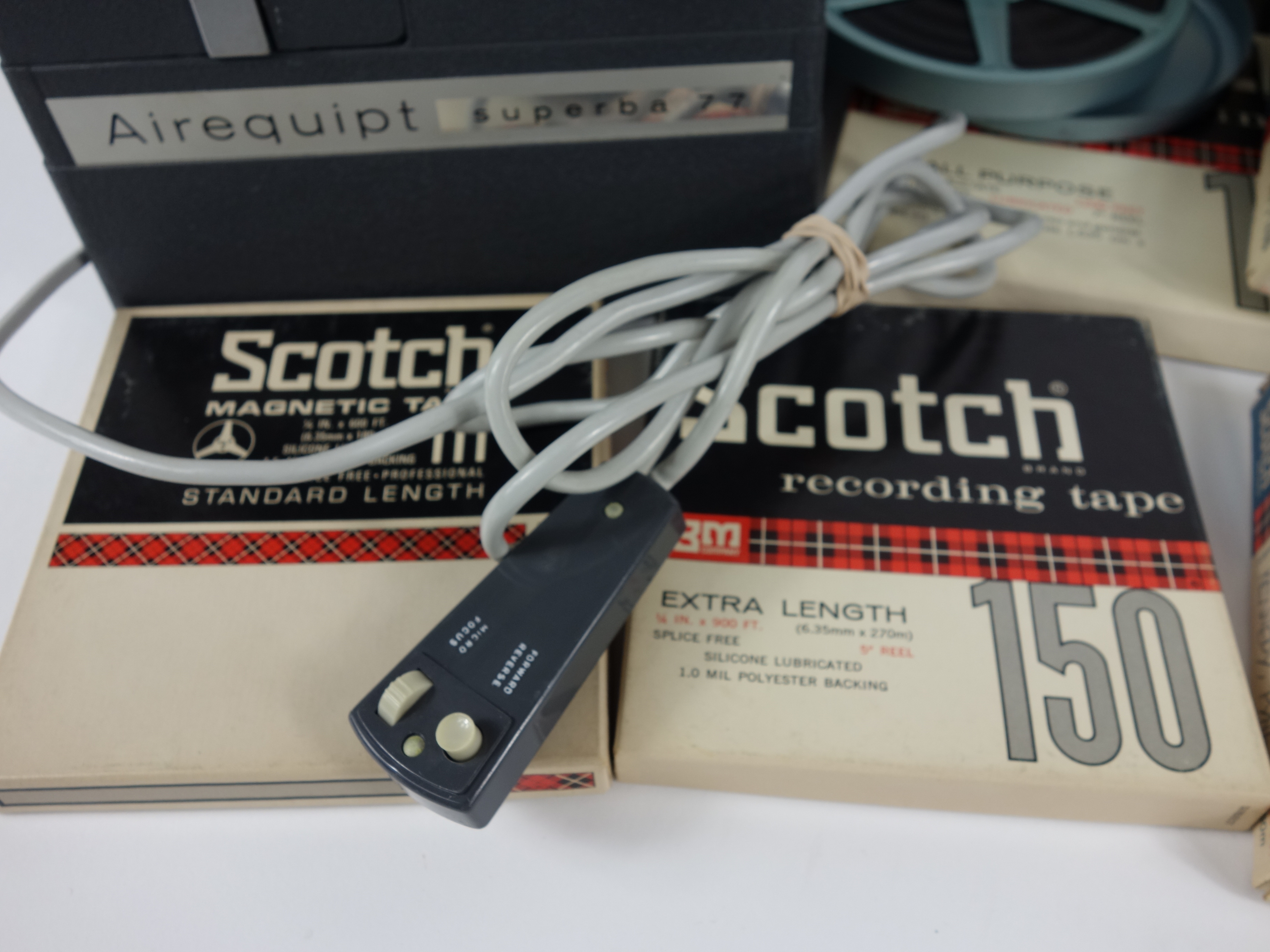 Projector and Vintage Tape Reels With News, Other Recordings