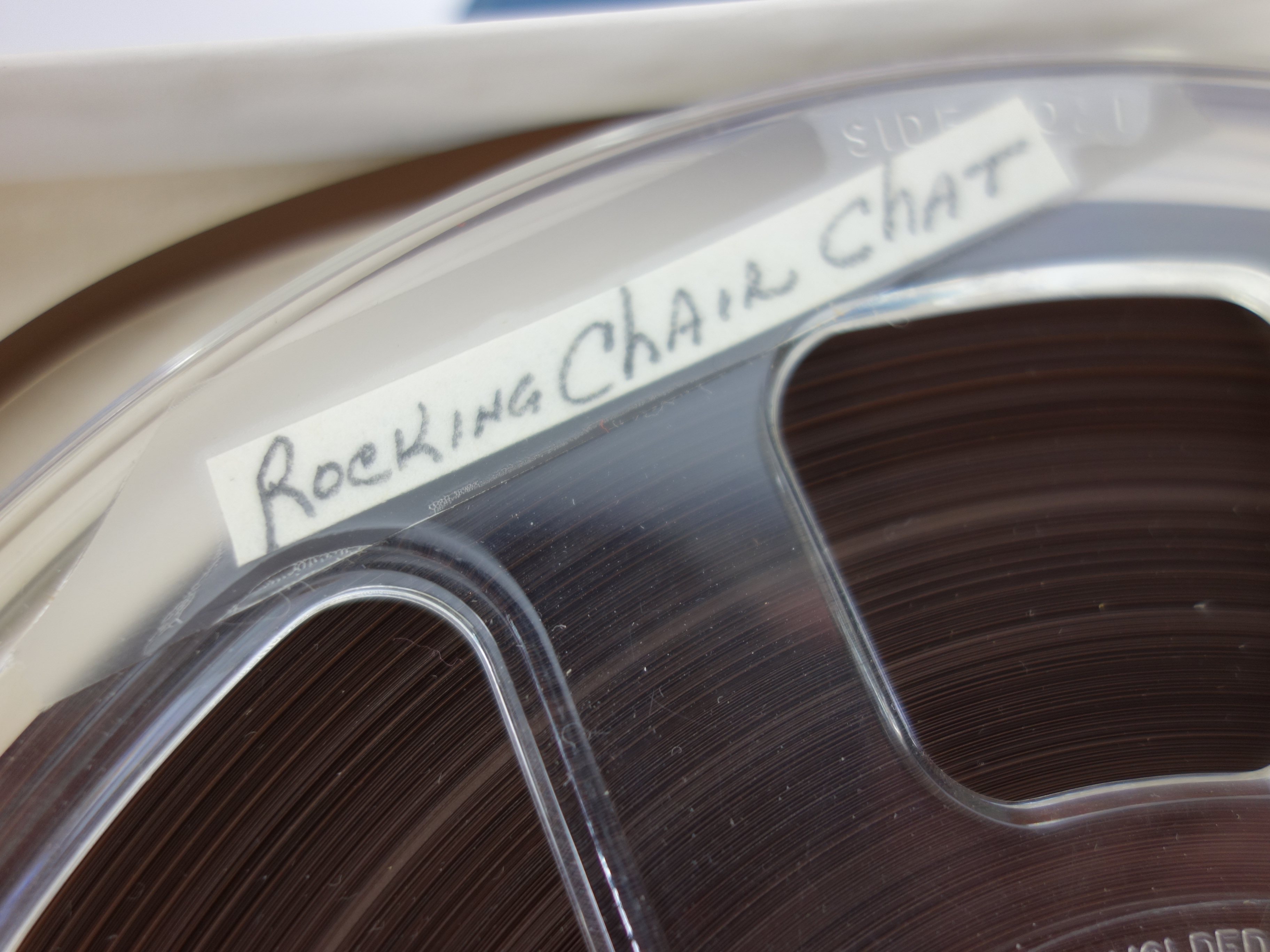 Projector and Vintage Tape Reels With News, Other Recordings