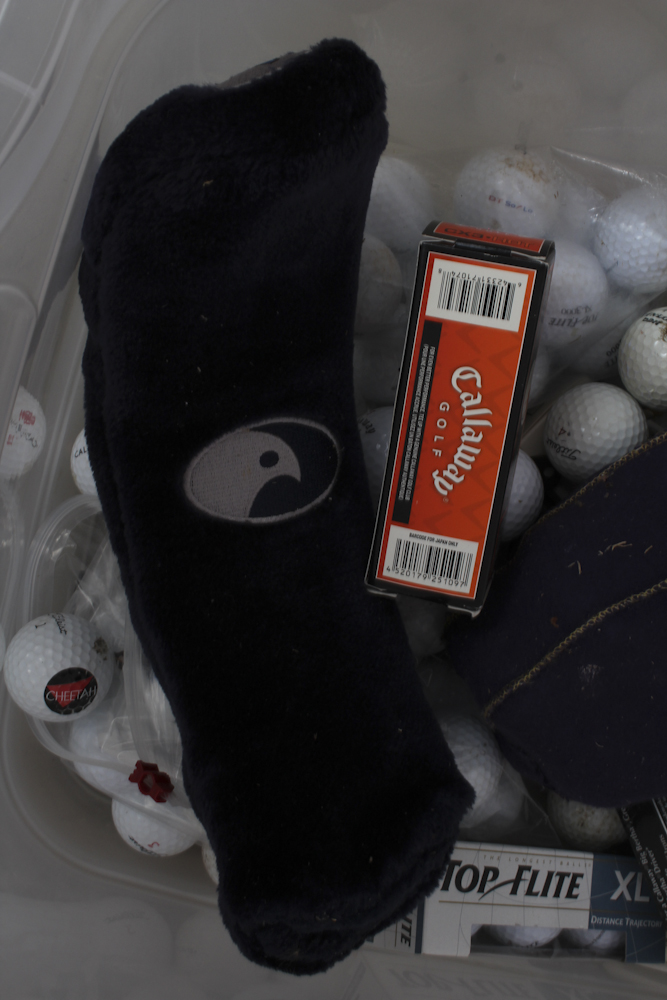 Assortment of Golf Clubs and Accessories