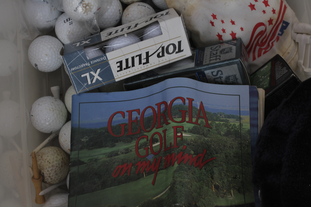 Assortment of Golf Clubs and Accessories