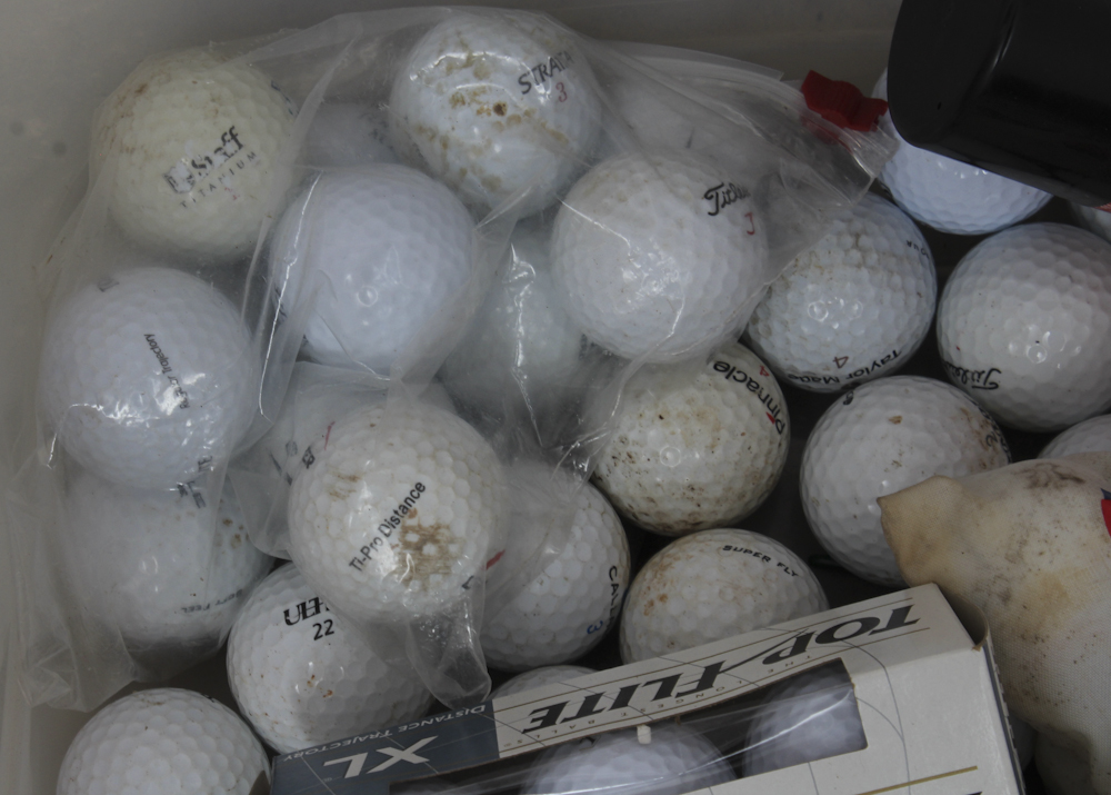 Assortment of Golf Clubs and Accessories