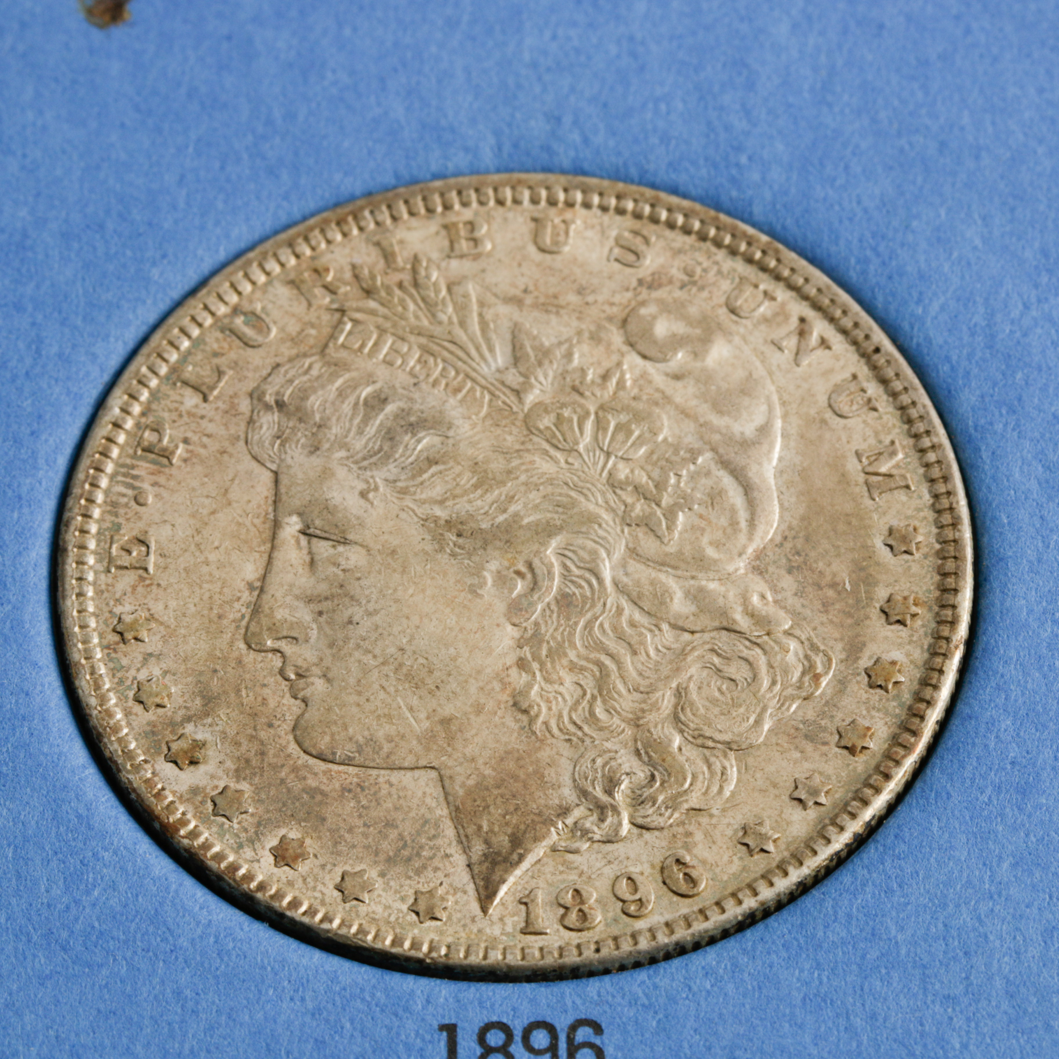 Group of 4 Silver Morgan Dollars in a Whitman Coin Folder Ranging in Age from 1891 to 1896