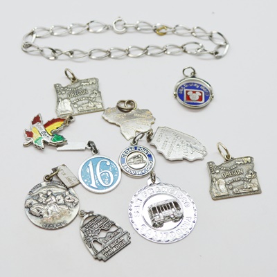 Eleven Sterling Silver Travel Charms and Charm Bracelet