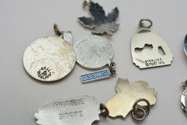 Eleven Sterling Silver Travel Charms and Charm Bracelet