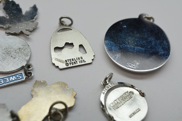 Eleven Sterling Silver Travel Charms and Charm Bracelet