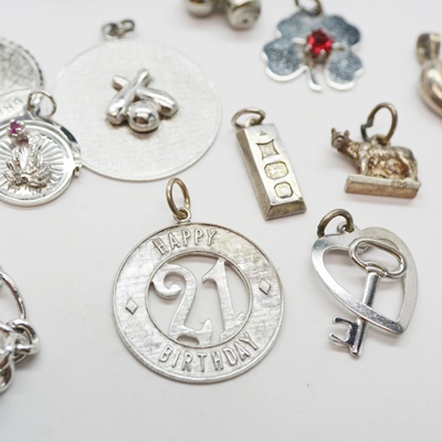 Thirteen Sterling Silver Charms and Charm Bracelet