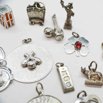 Thirteen Sterling Silver Charms and Charm Bracelet