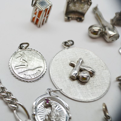 Thirteen Sterling Silver Charms and Charm Bracelet