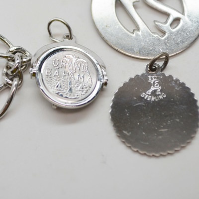 Thirteen Sterling Silver Charms and Charm Bracelet