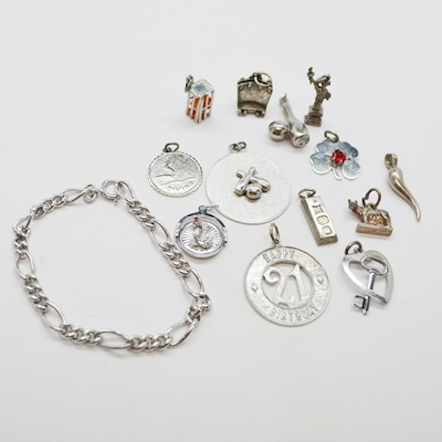 Thirteen Sterling Silver Charms and Charm Bracelet
