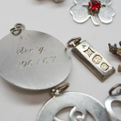 Thirteen Sterling Silver Charms and Charm Bracelet