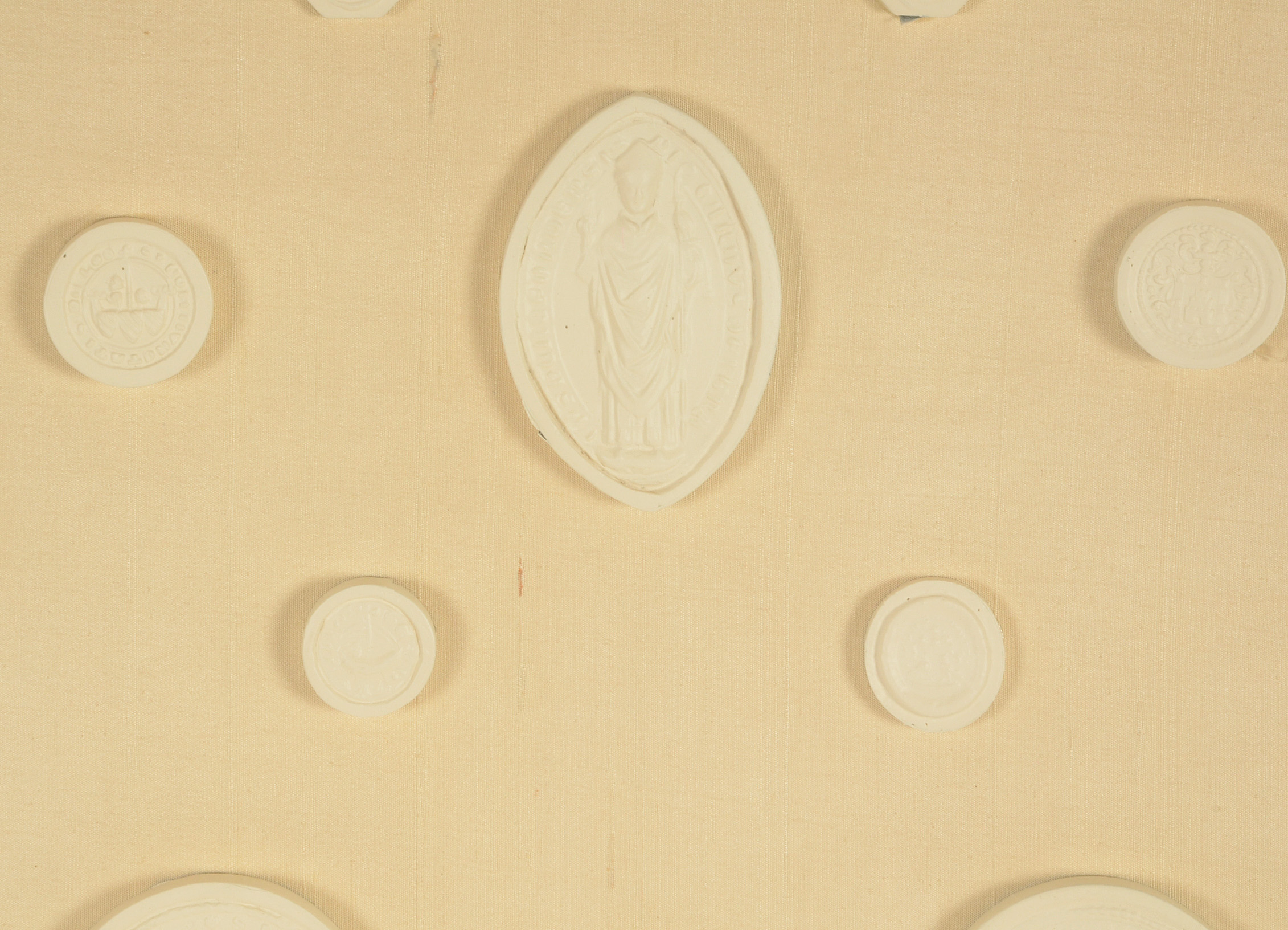 Framed Display of Plaster Intaglio Molds After Medieval Seals