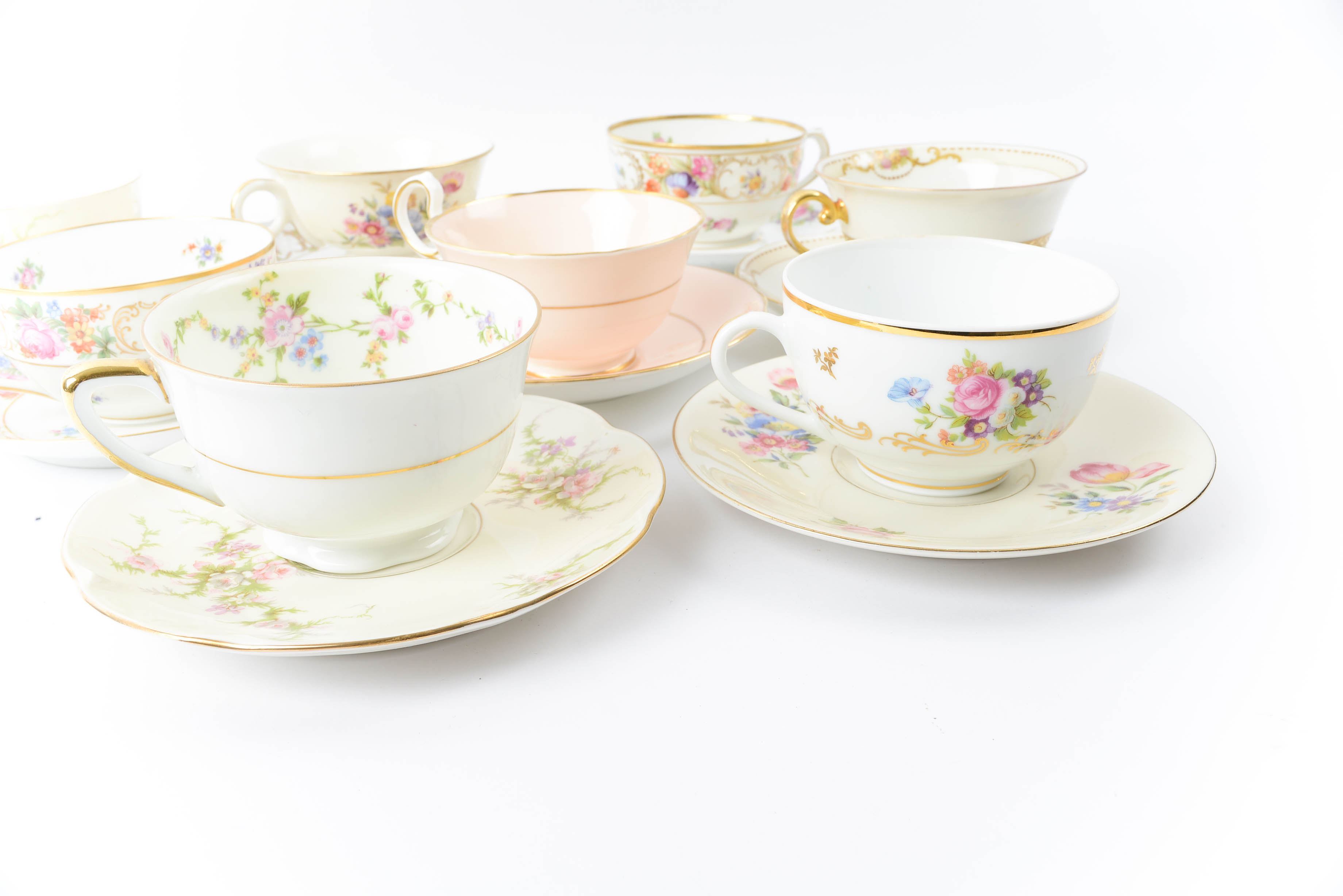 Assortment of Teacups and Matching Saucers
