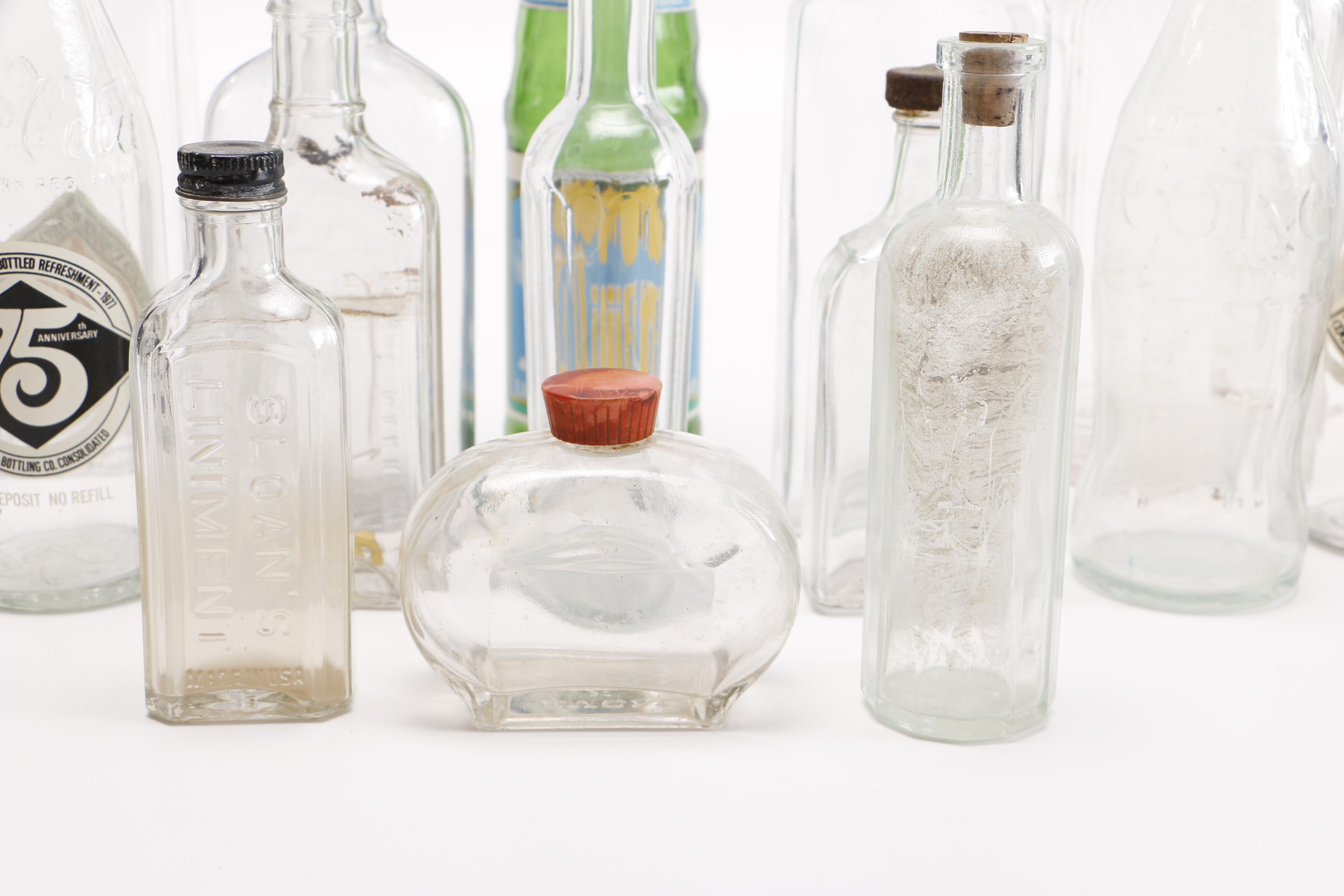 Vintage Glass Bottles Including Coca-Cola, Sloan's Liniment and Three Feathers Whiskey