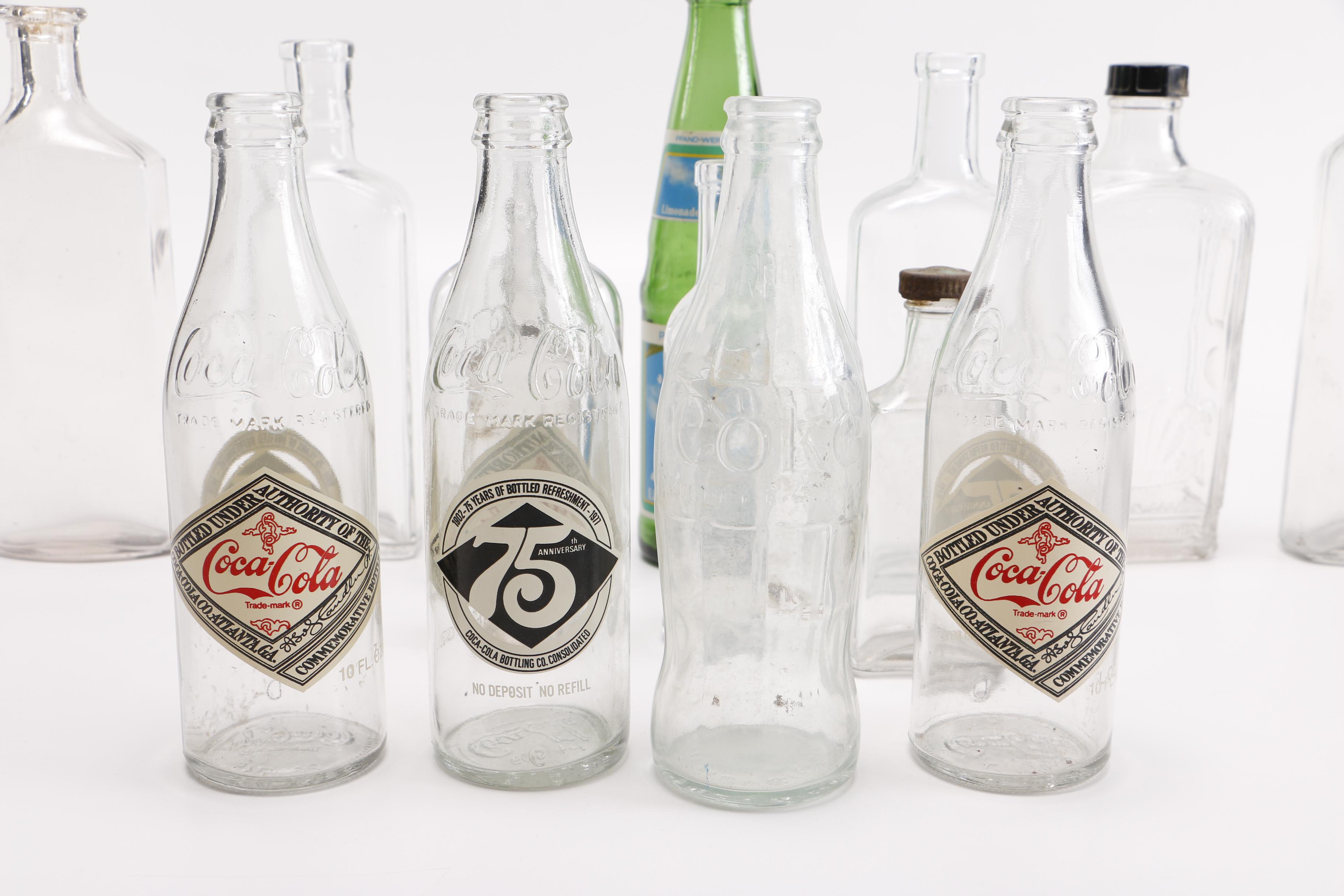 Vintage Glass Bottles Including Coca-Cola, Sloan's Liniment and Three Feathers Whiskey