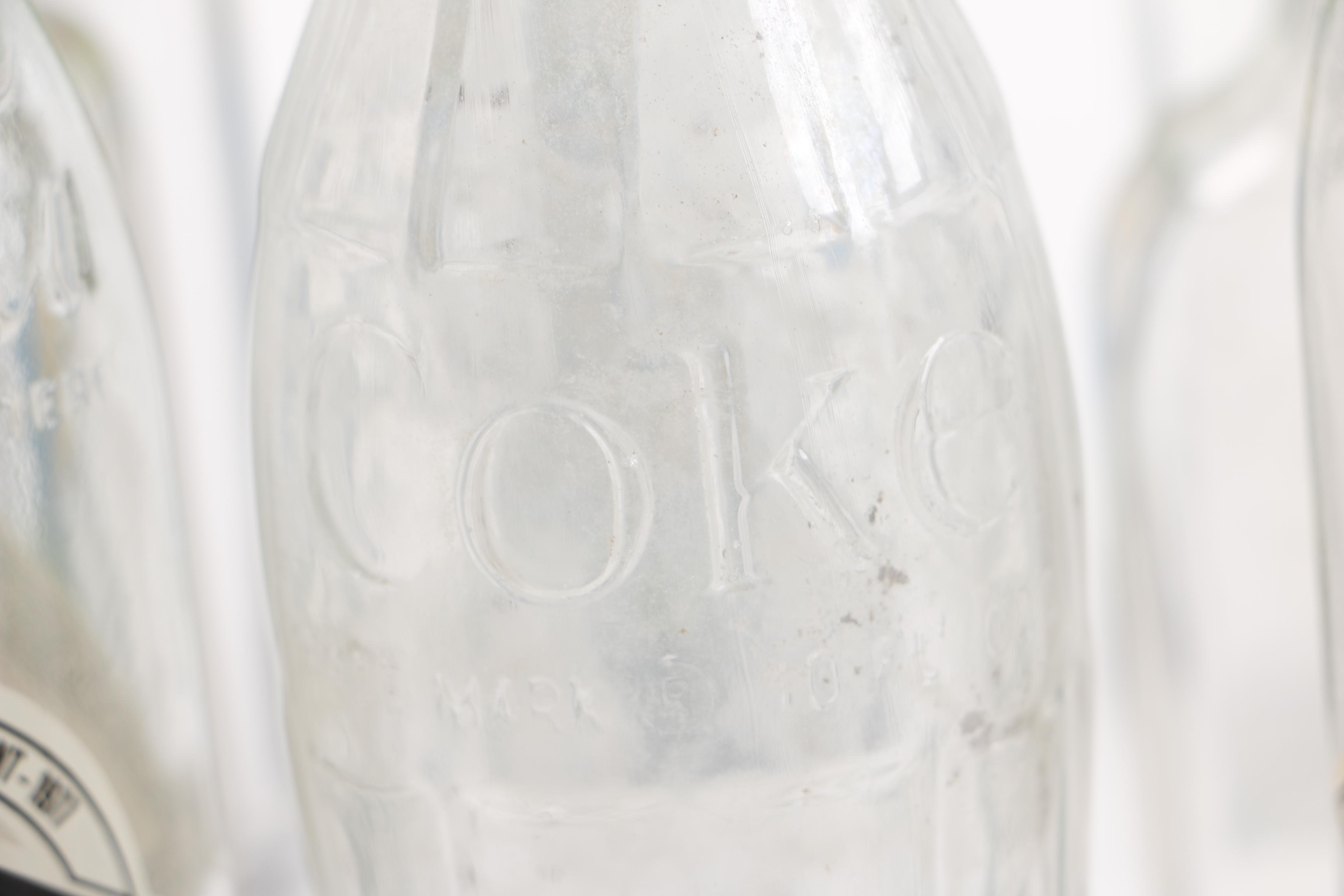 Vintage Glass Bottles Including Coca-Cola, Sloan's Liniment and Three Feathers Whiskey