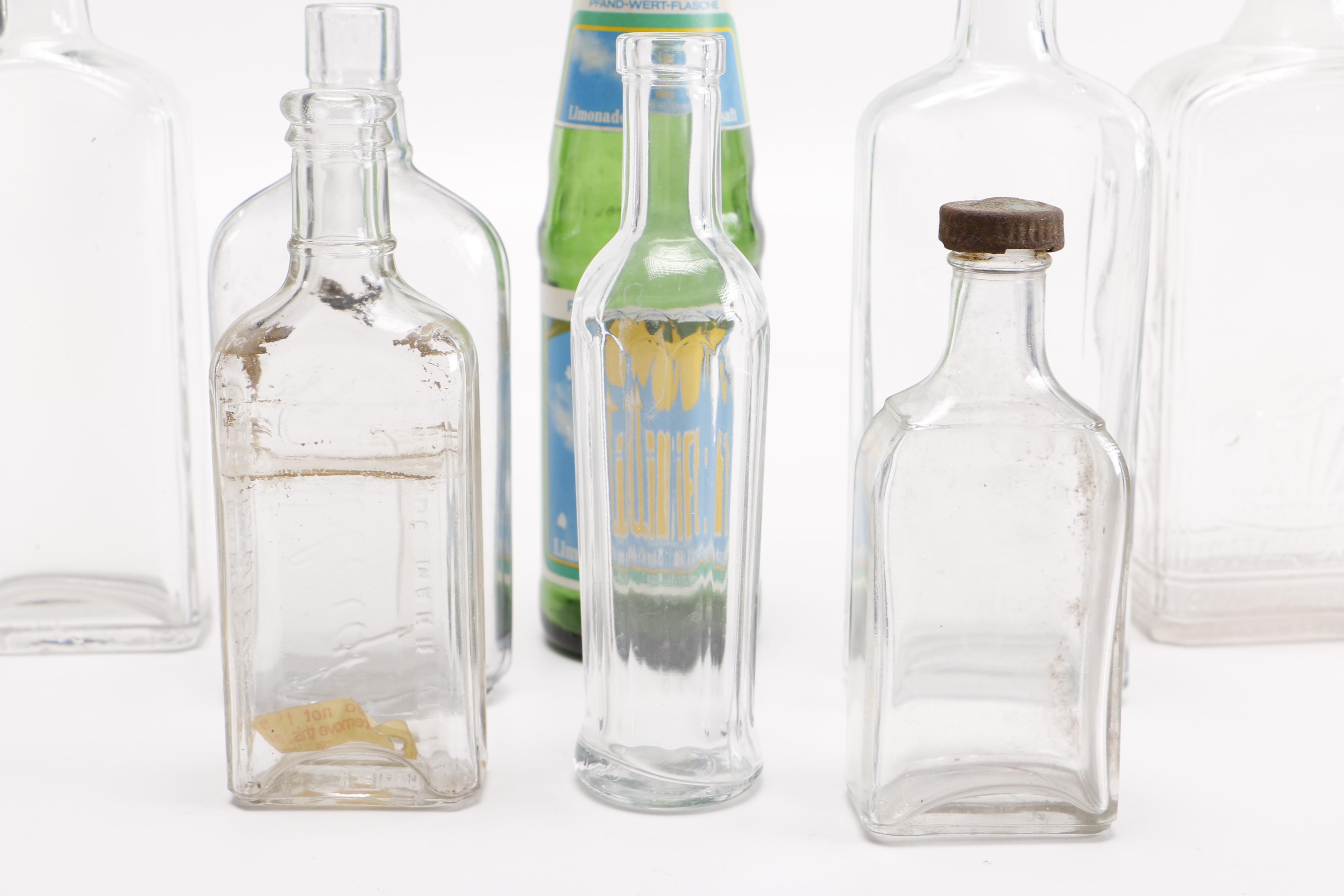 Vintage Glass Bottles Including Coca-Cola, Sloan's Liniment and Three Feathers Whiskey