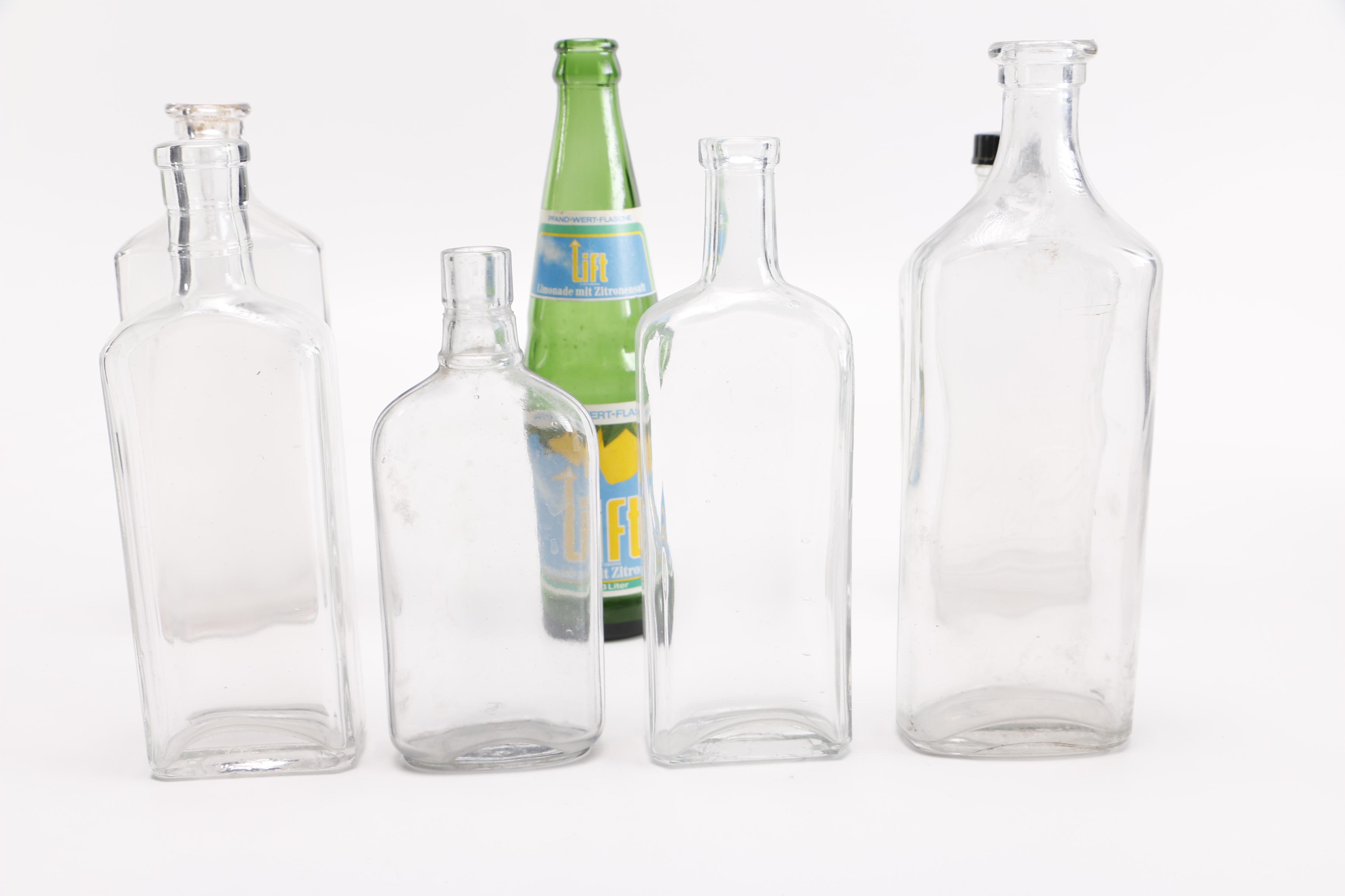 Vintage Glass Bottles Including Coca-Cola, Sloan's Liniment and Three Feathers Whiskey