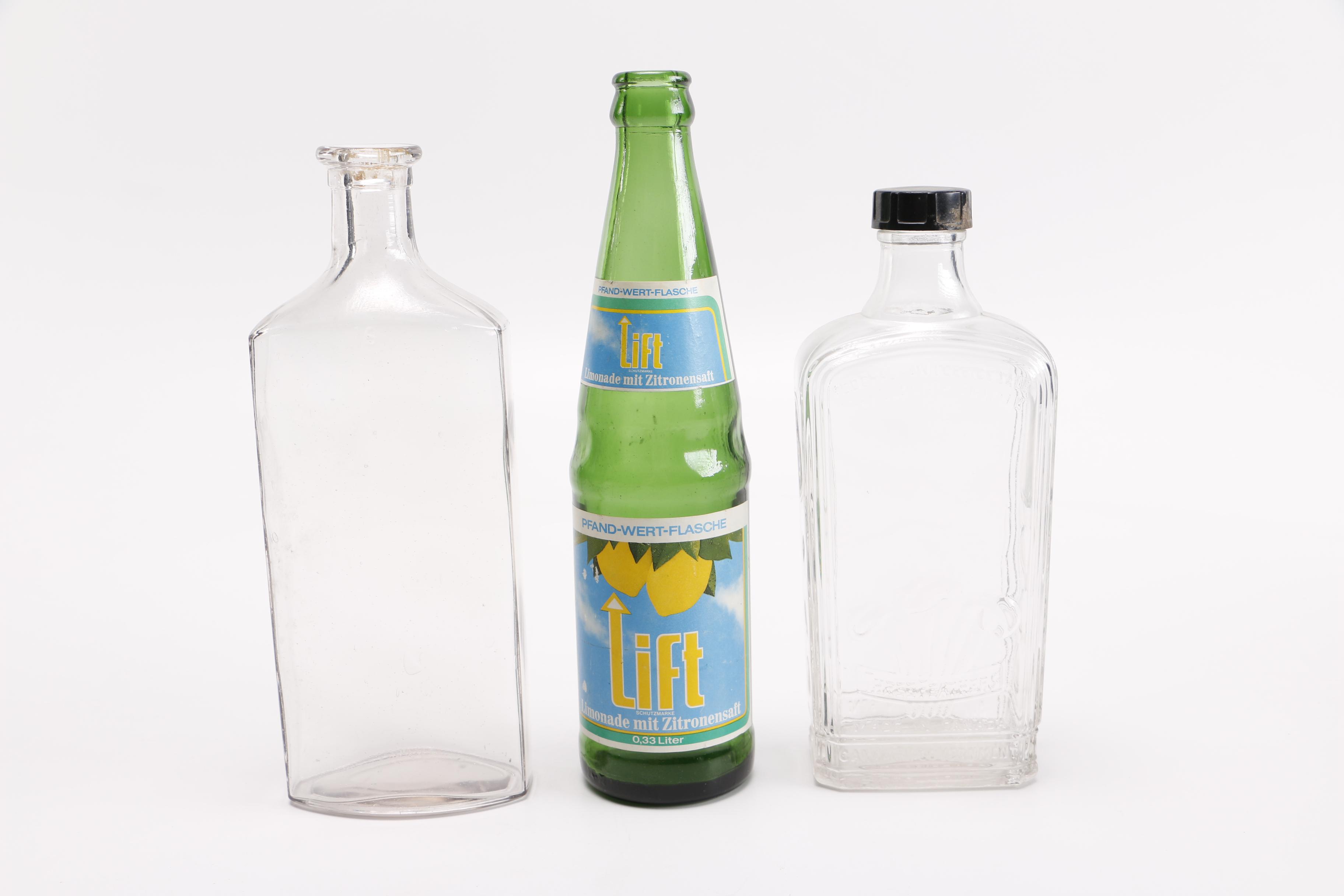 Vintage Glass Bottles Including Coca-Cola, Sloan's Liniment and Three Feathers Whiskey