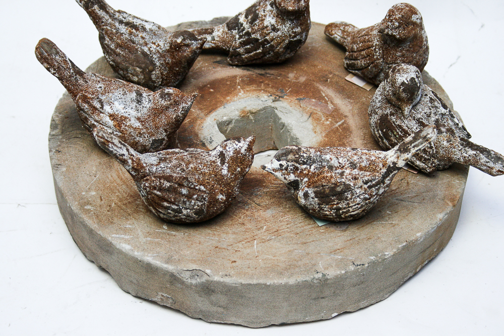 Collection of Decorative Birds on a Grinding Stone