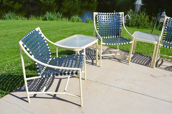 Four Cream Aluminum Patio Chairs and Two Side Tables