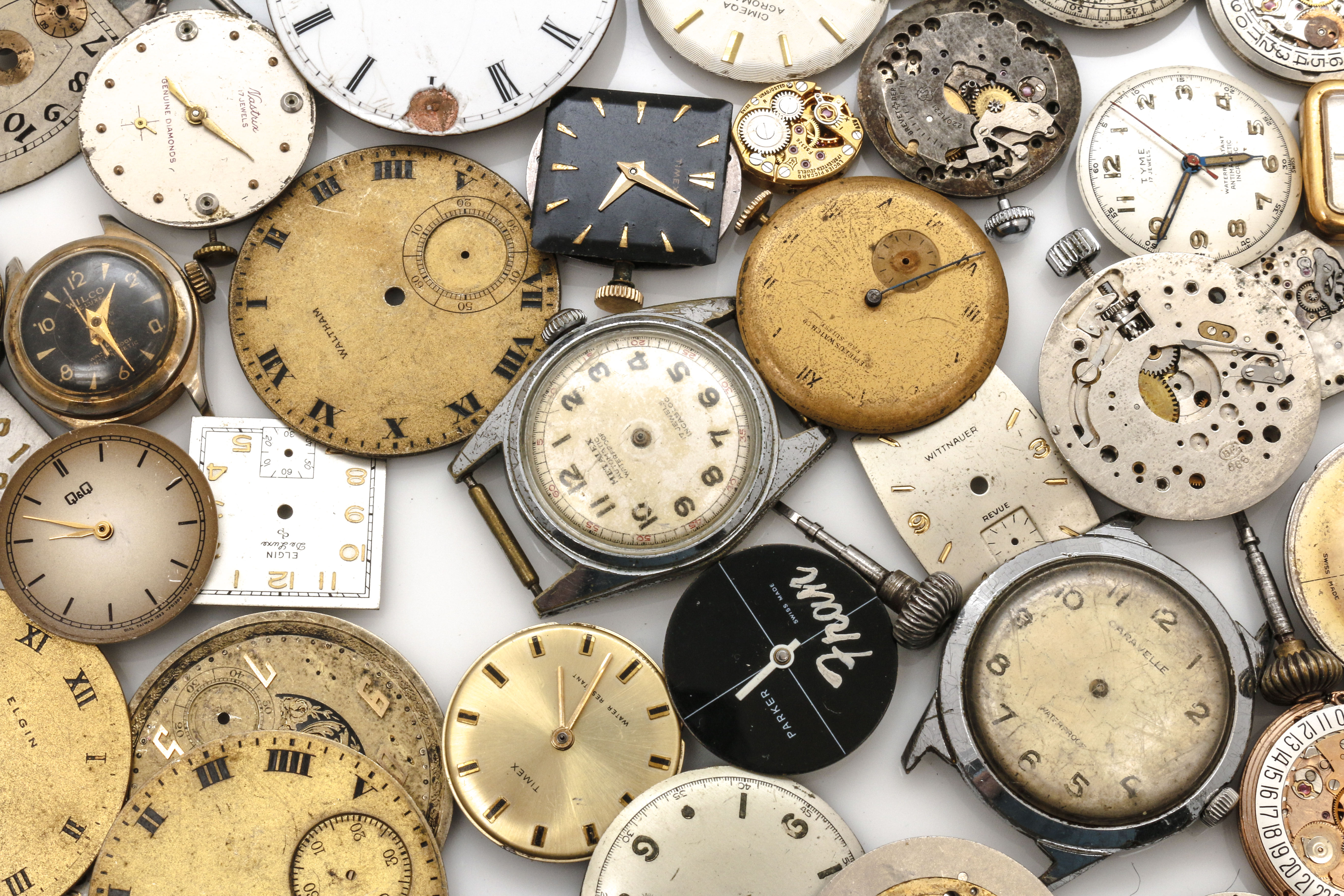 Assortment of Watch Movements, Dials, Cases, and Parts