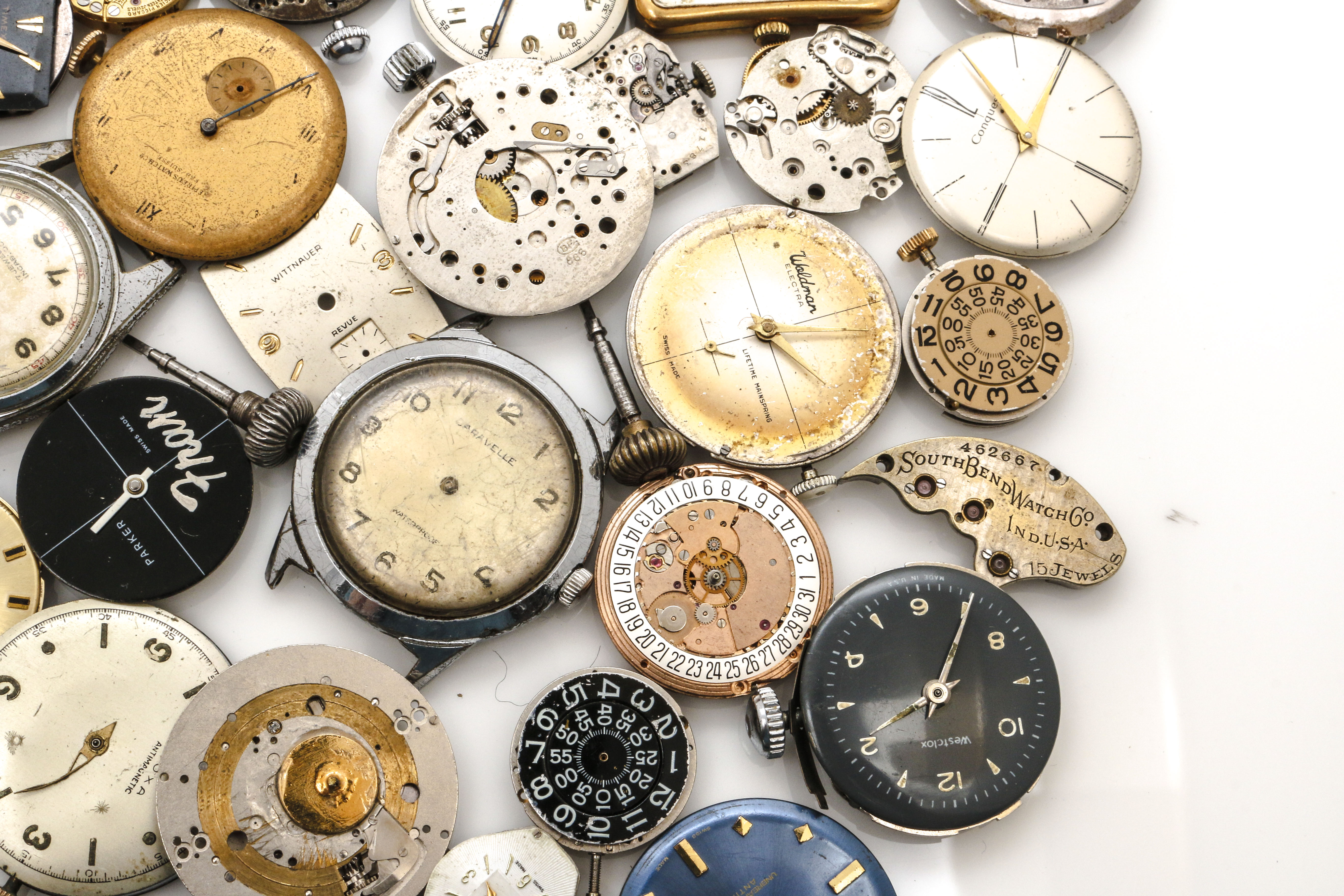 Assortment of Watch Movements, Dials, Cases, and Parts