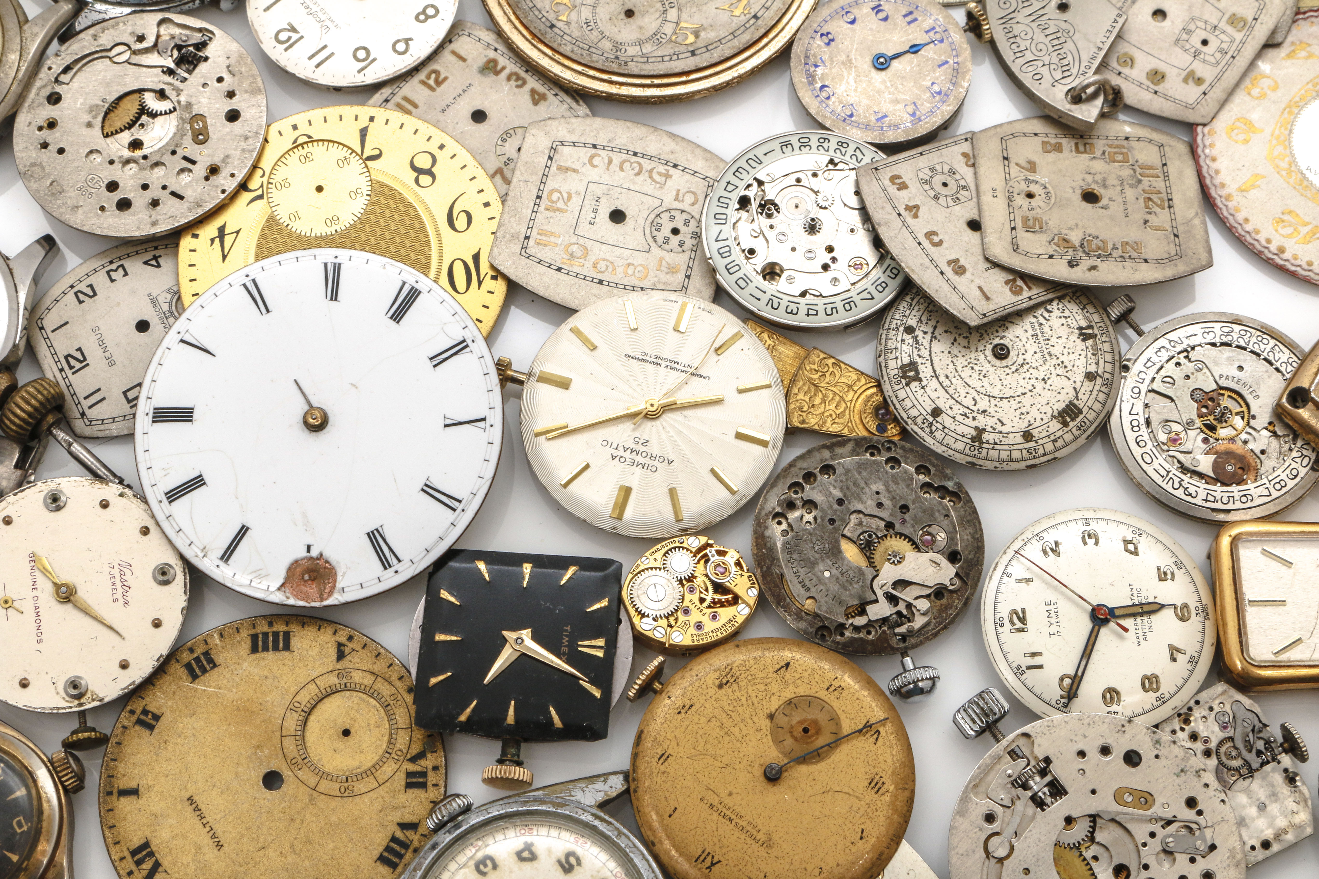 Assortment of Watch Movements, Dials, Cases, and Parts