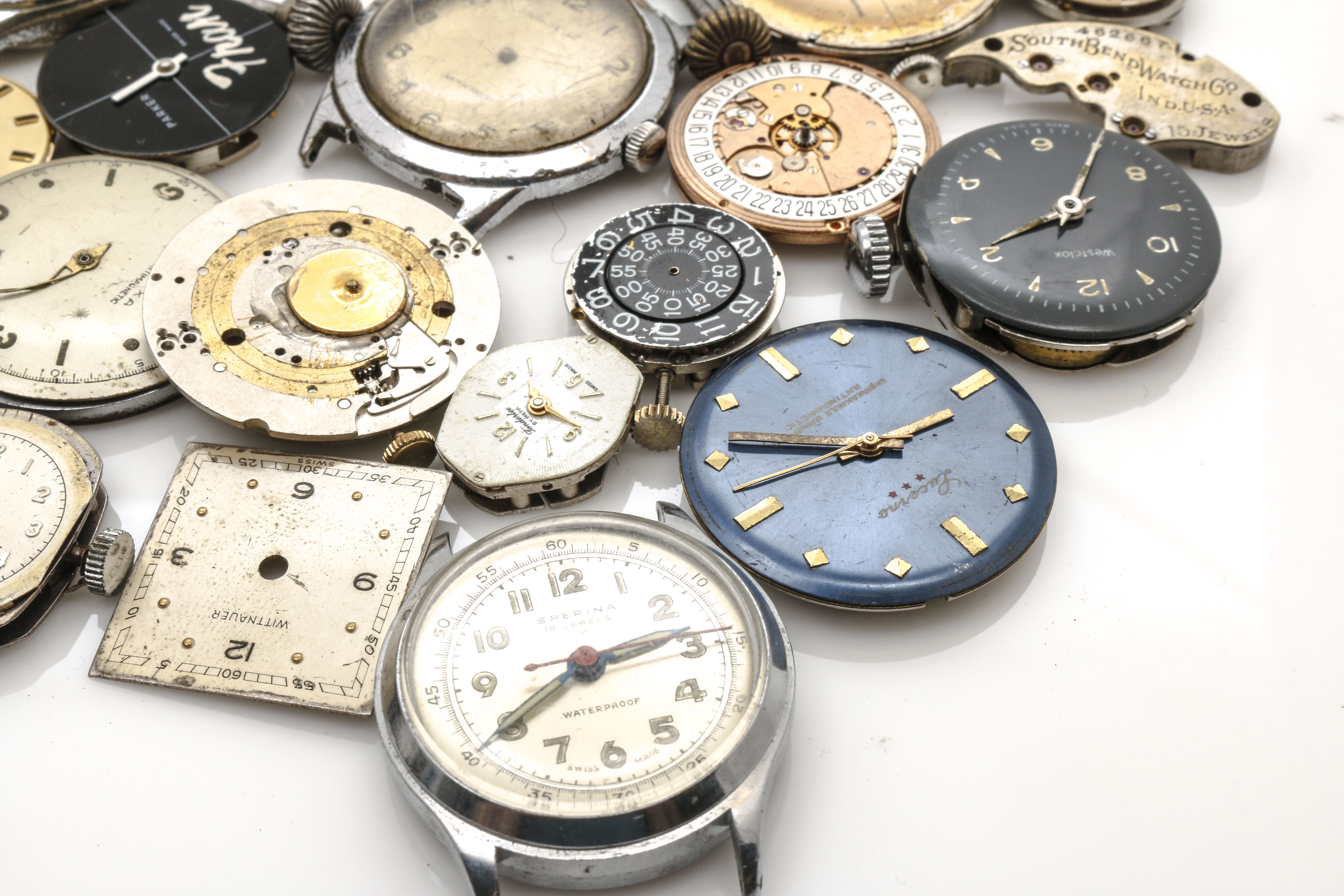 Assortment of Watch Movements, Dials, Cases, and Parts