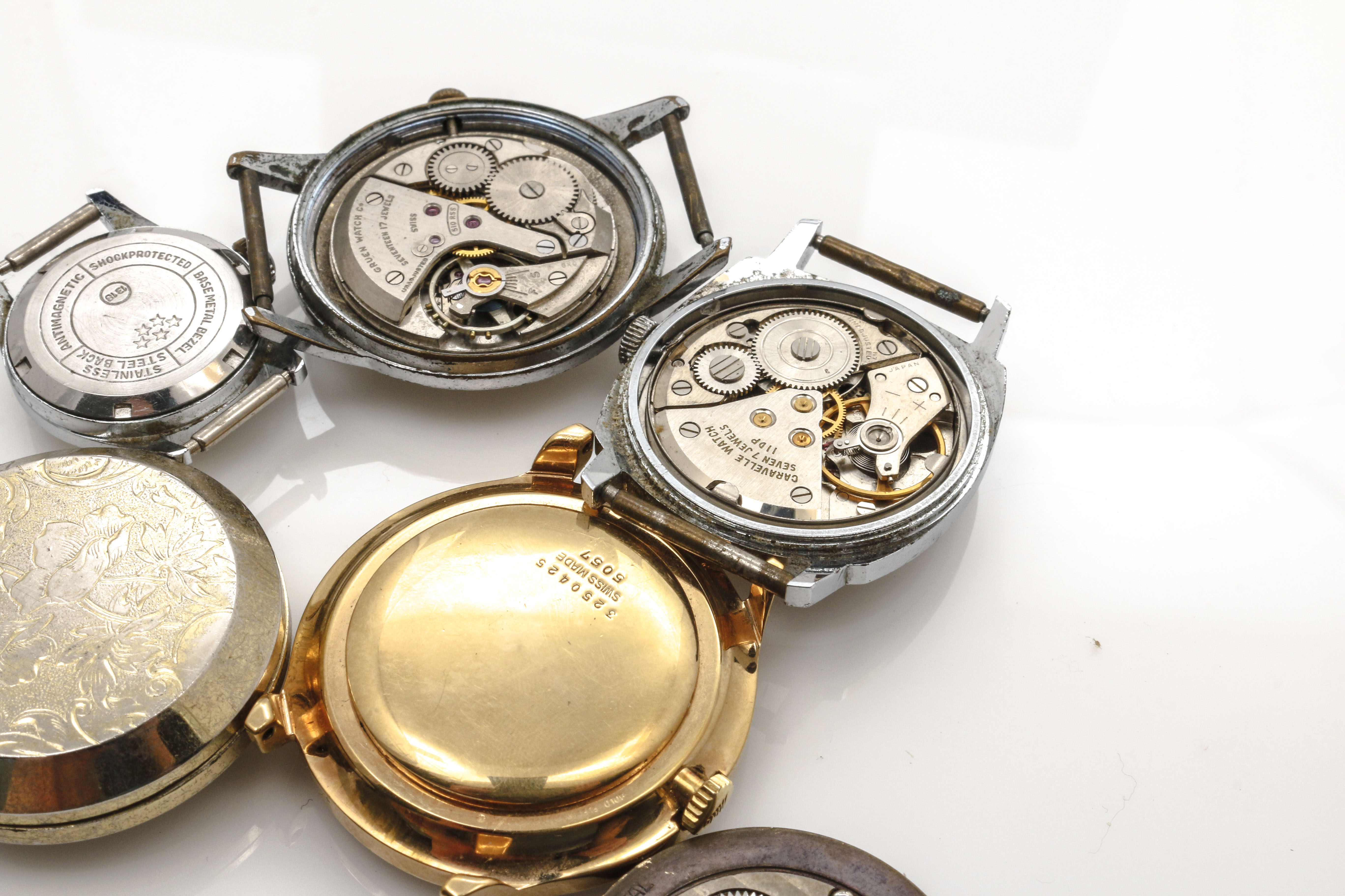 Assortment of Watch Movements, Dials, Cases, and Parts