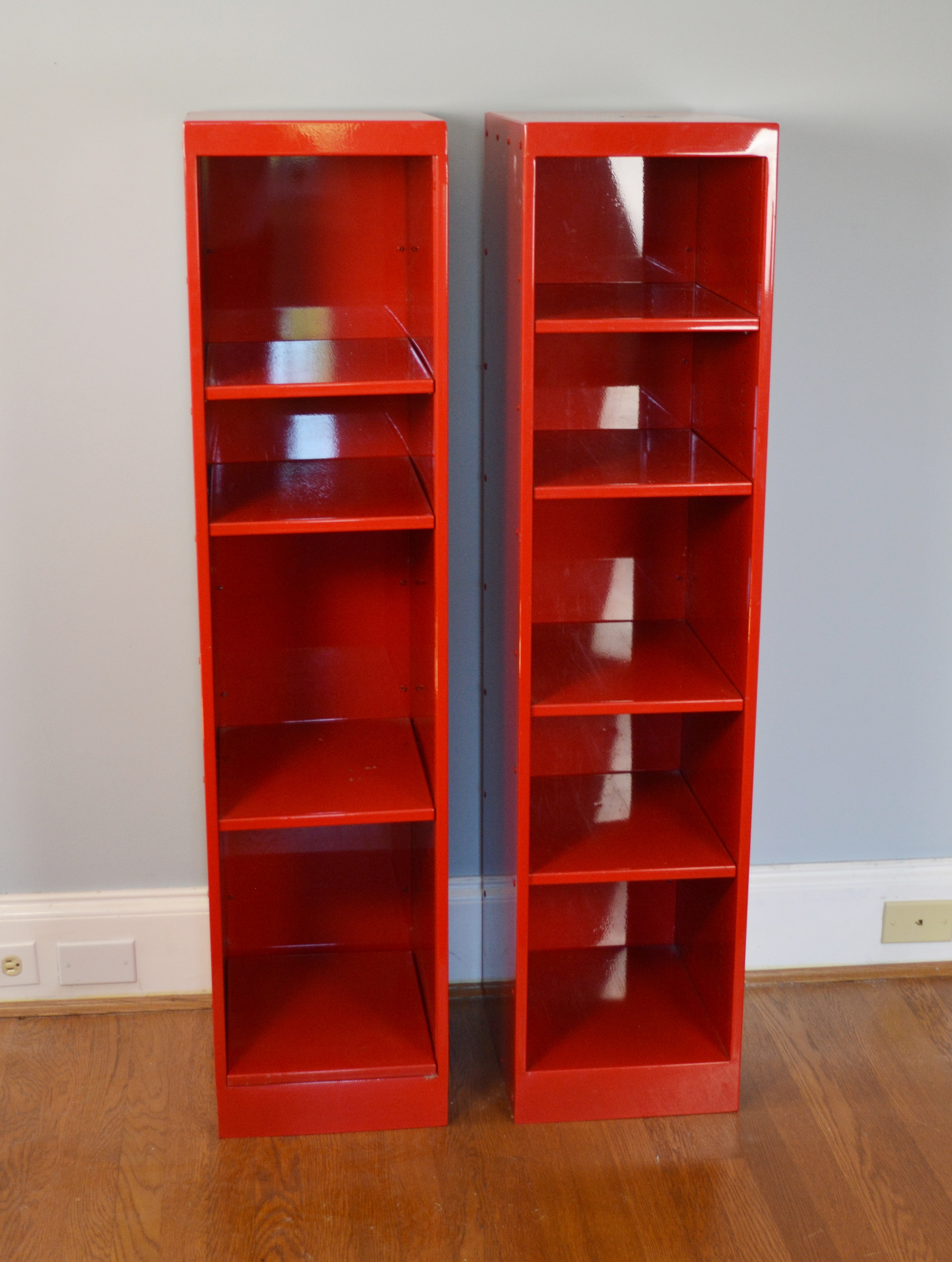 Two Red Metal Shelf Units