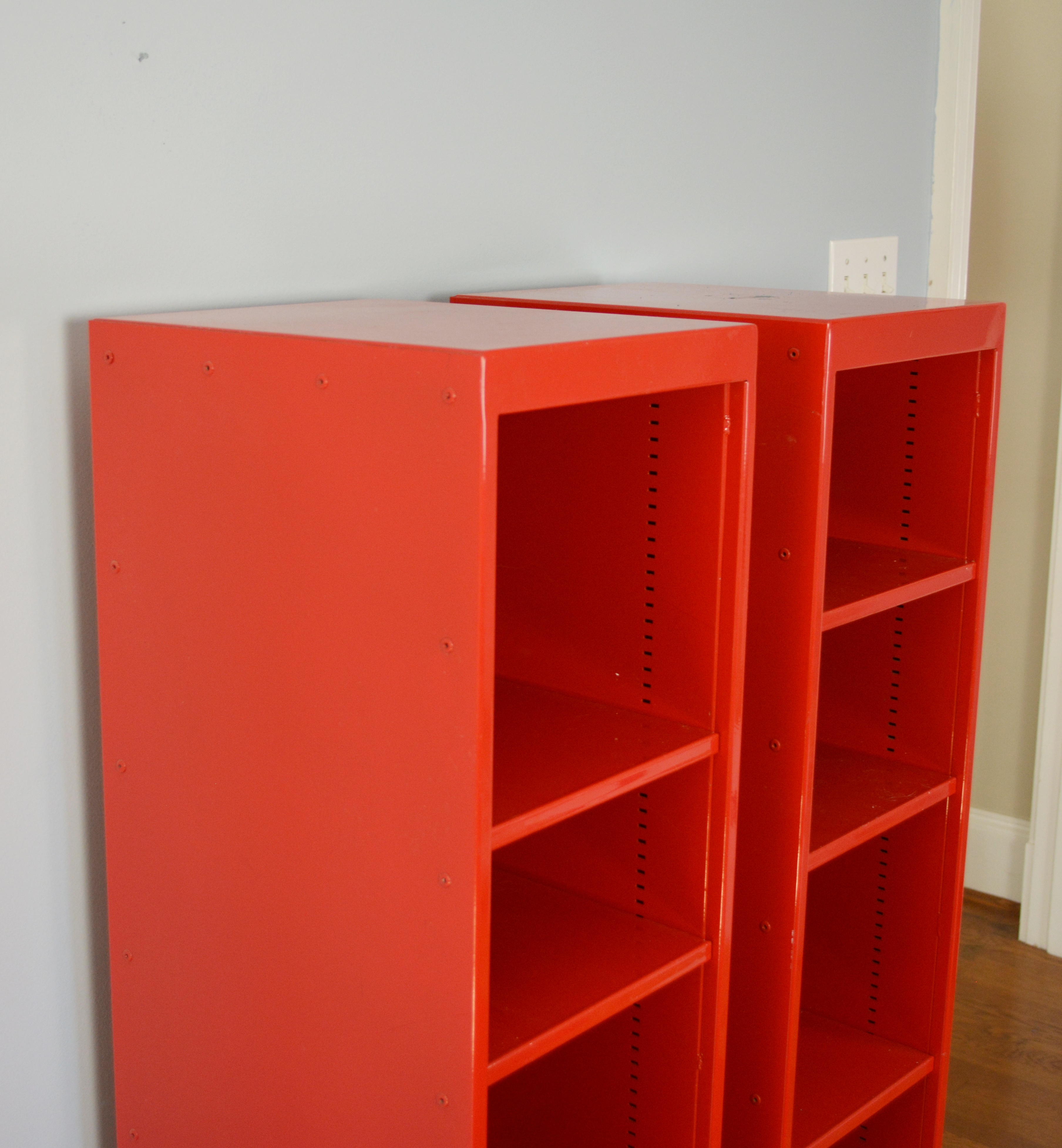 Two Red Metal Shelf Units