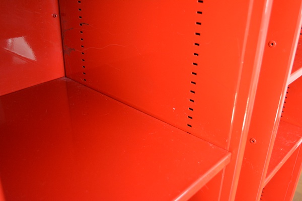 Two Red Metal Shelf Units