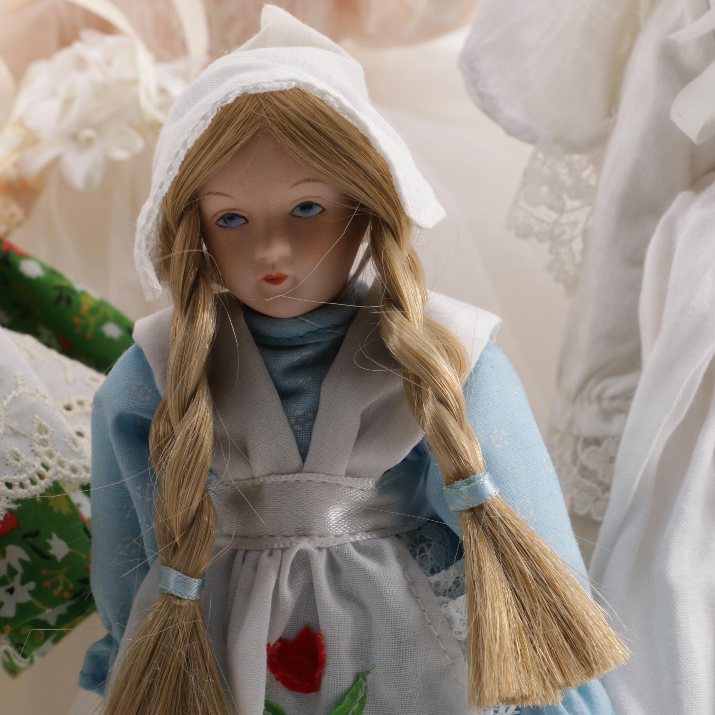 Doll Collection Including Madame Alexander, a Pierrot, and a Three-Faced Baby Doll