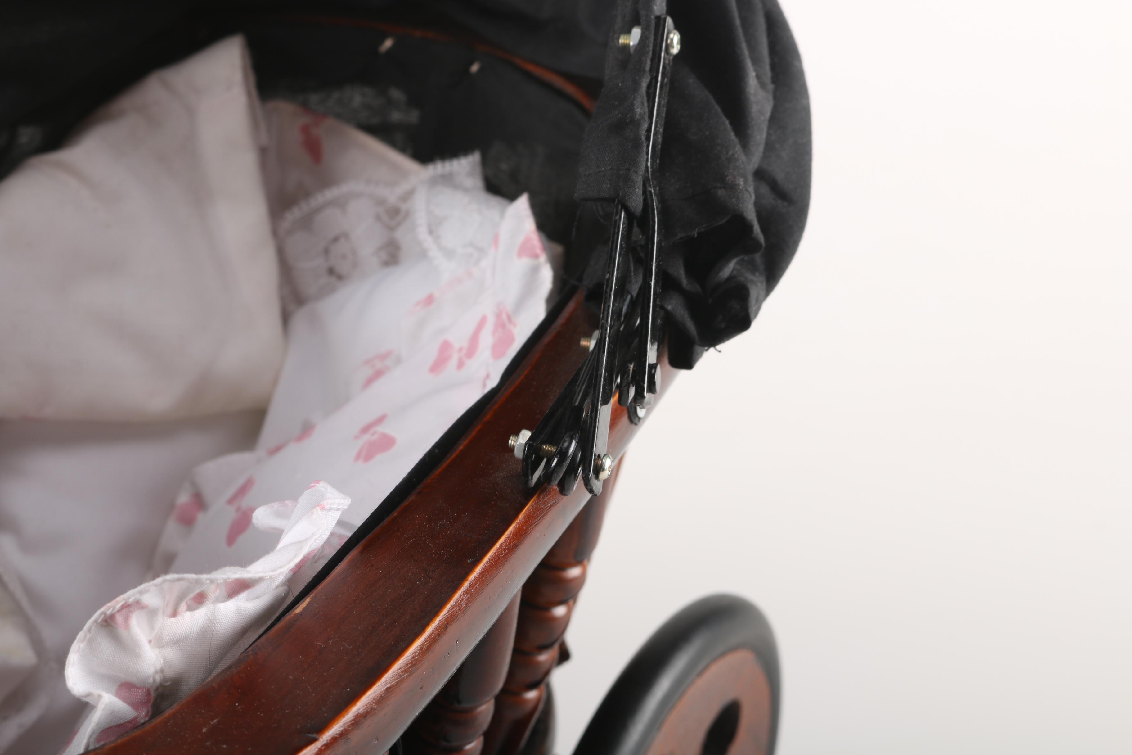 Porcelain Baby Doll in Cherry Finish Doll Pram