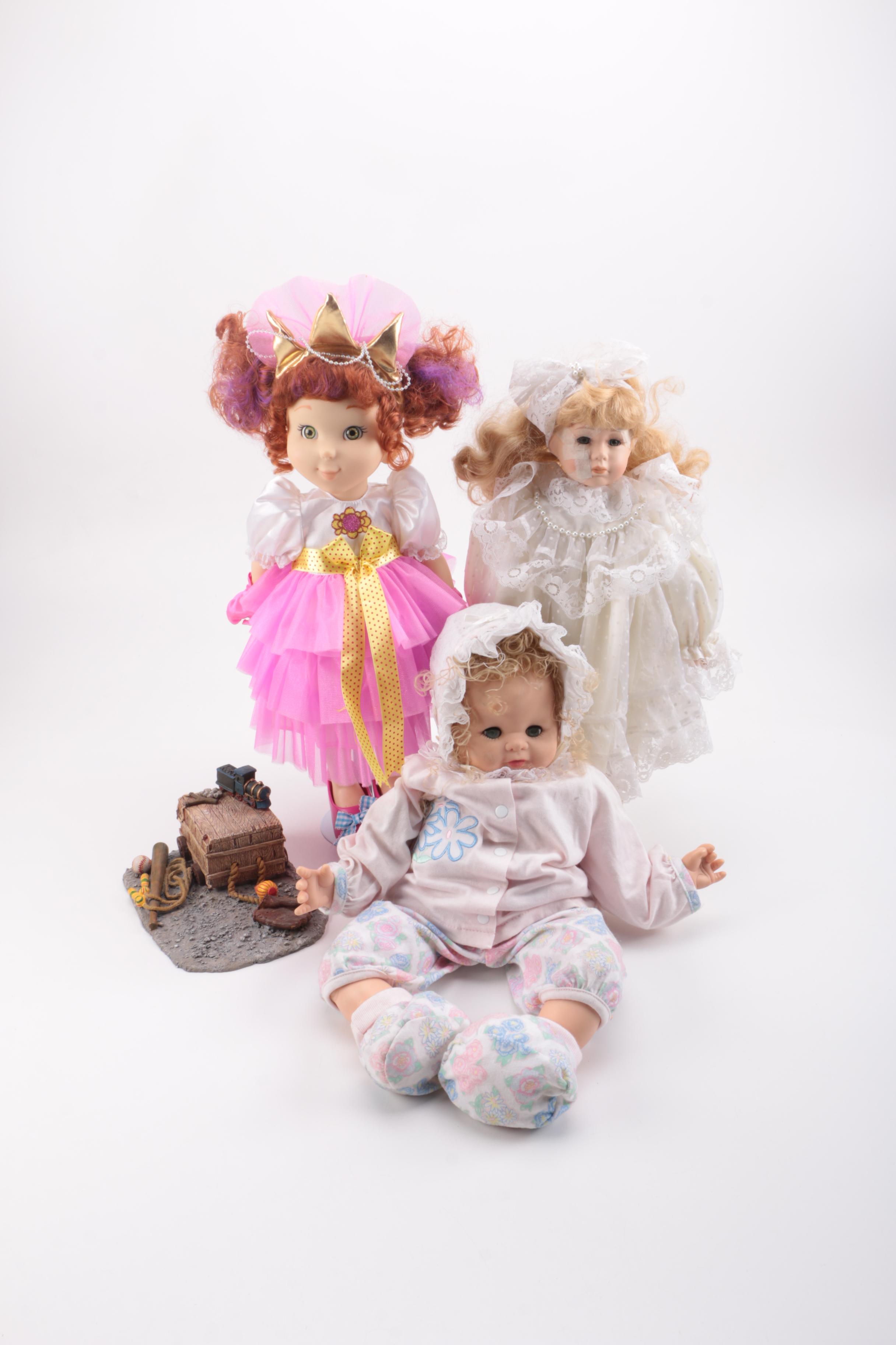 Assortment of Dolls and a Ceramic Toy Figurine