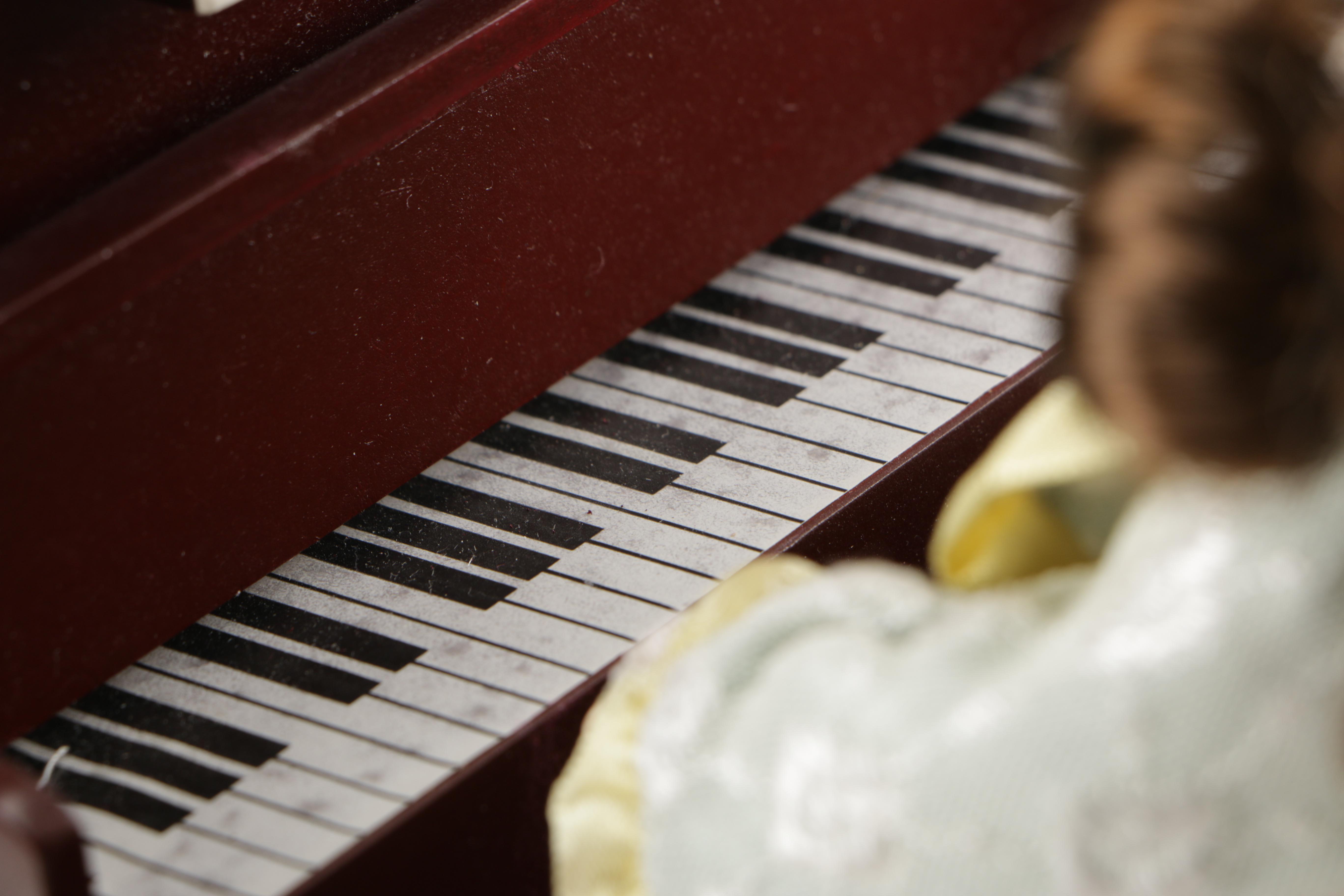 Porcelain Doll Playing Piano