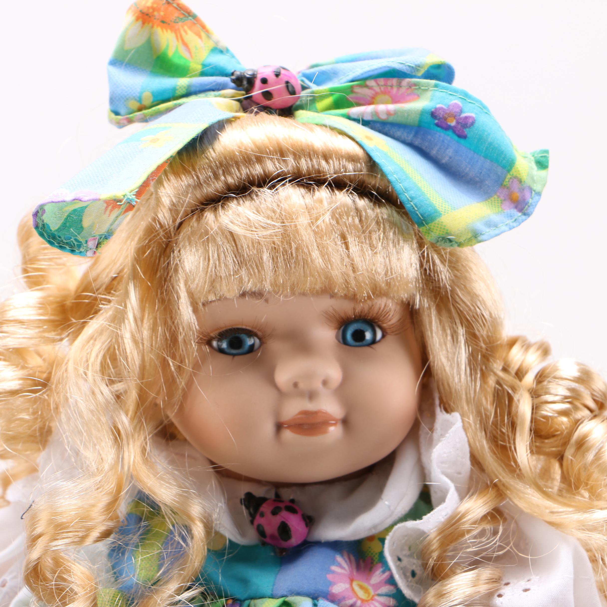 Porcelain Dolls and Accessories in Dresser