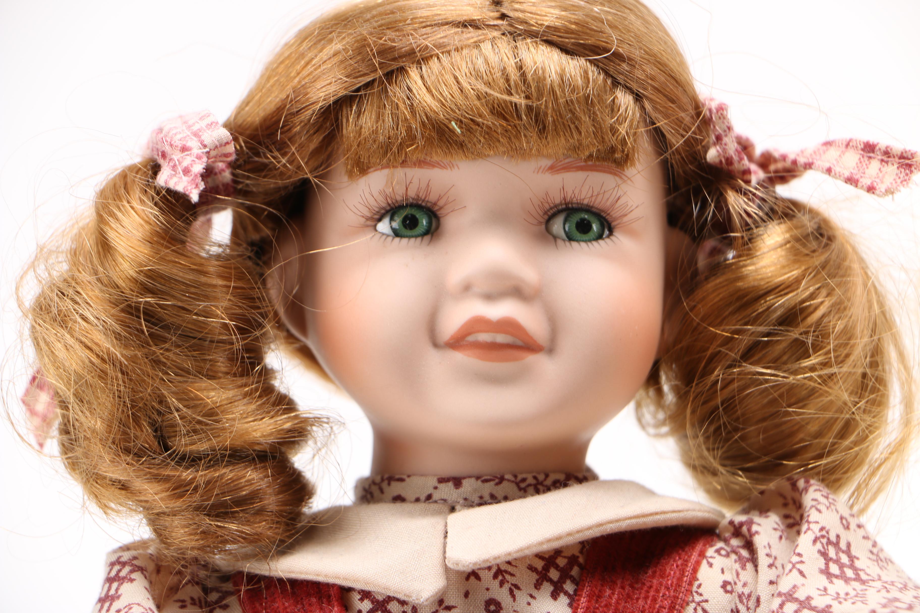 Porcelain Dolls and Accessories in Dresser