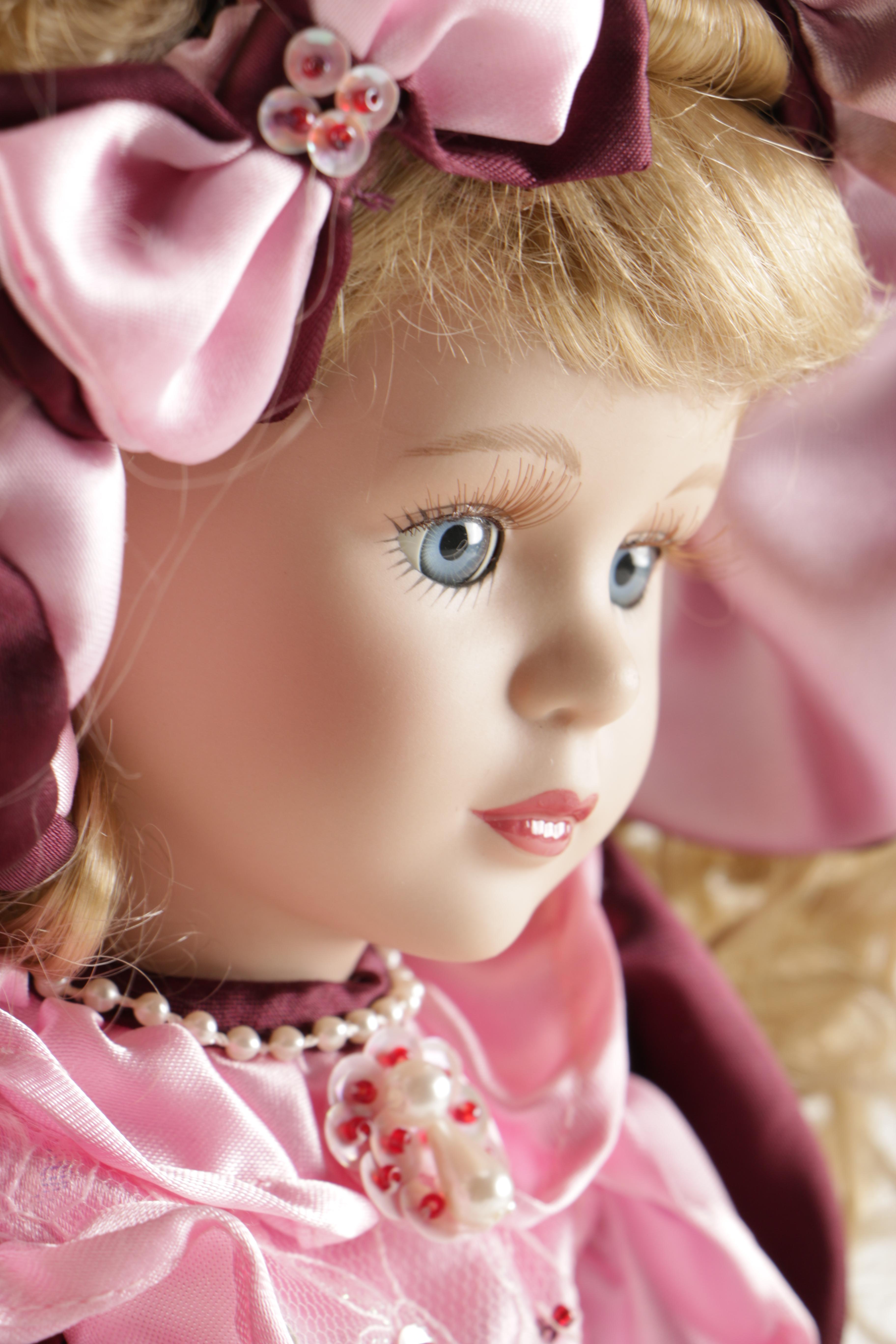 Assortment of Porcelain Dolls in Pink Dresses