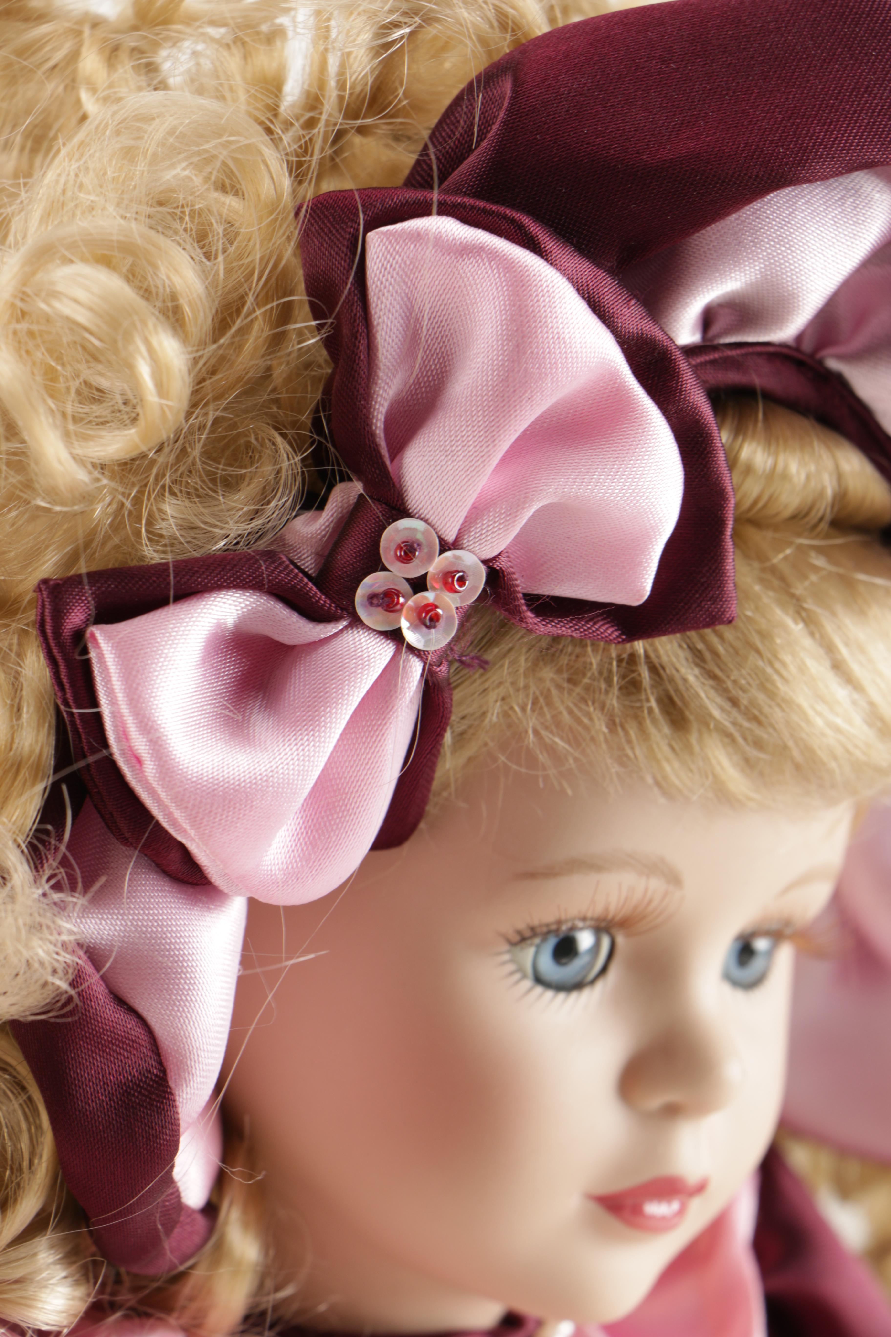 Assortment of Porcelain Dolls in Pink Dresses