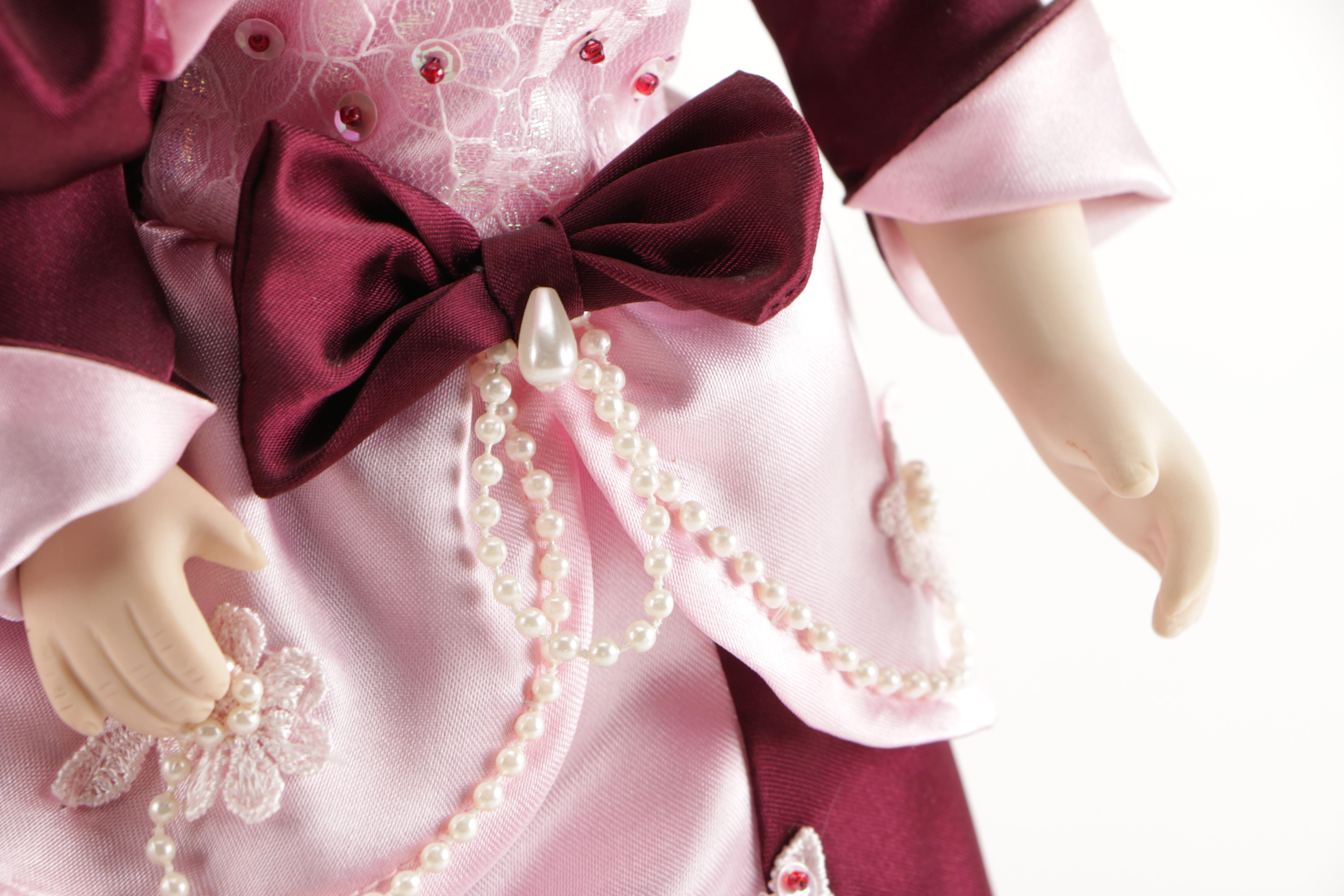 Assortment of Porcelain Dolls in Pink Dresses