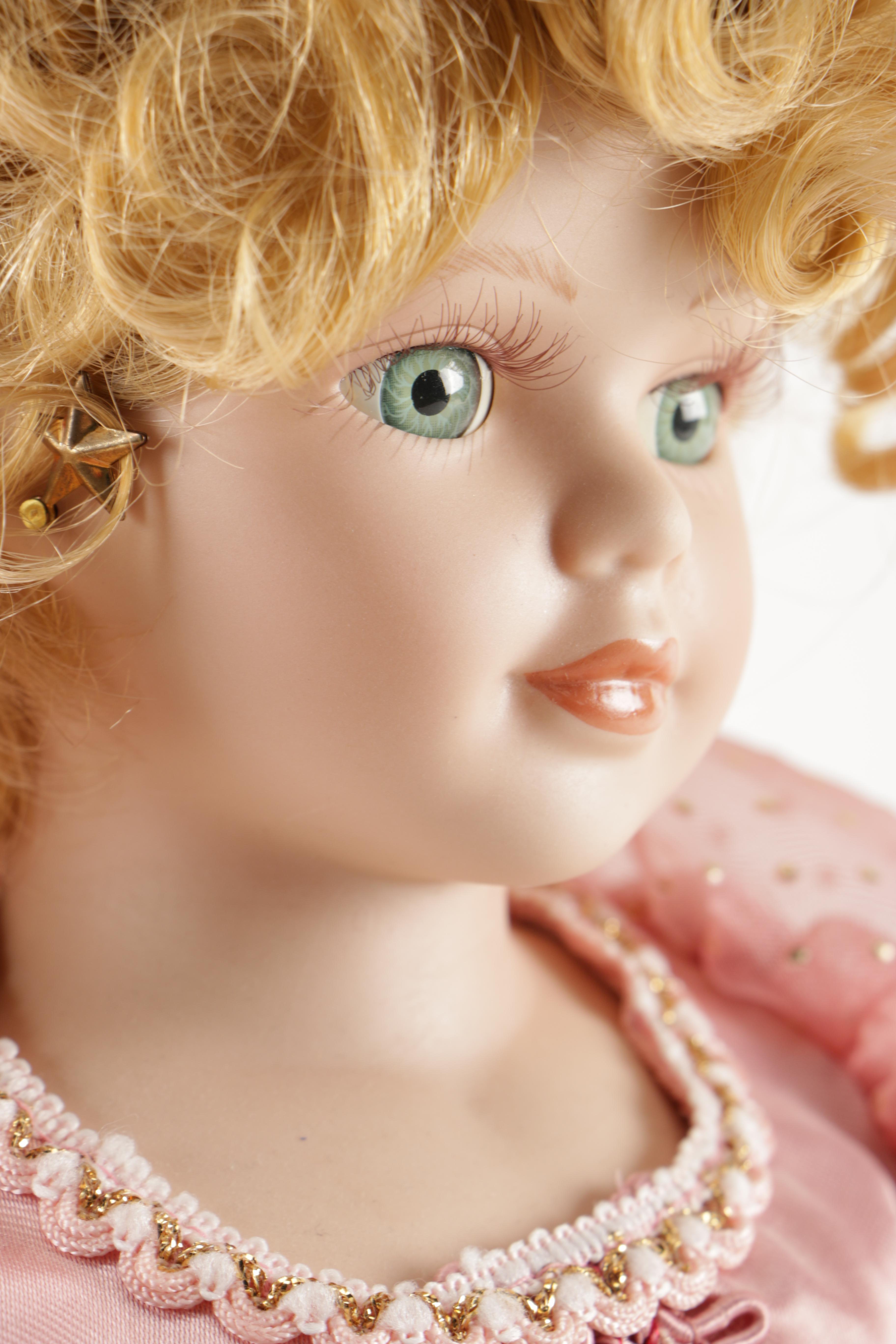 Assortment of Porcelain Dolls in Pink Dresses