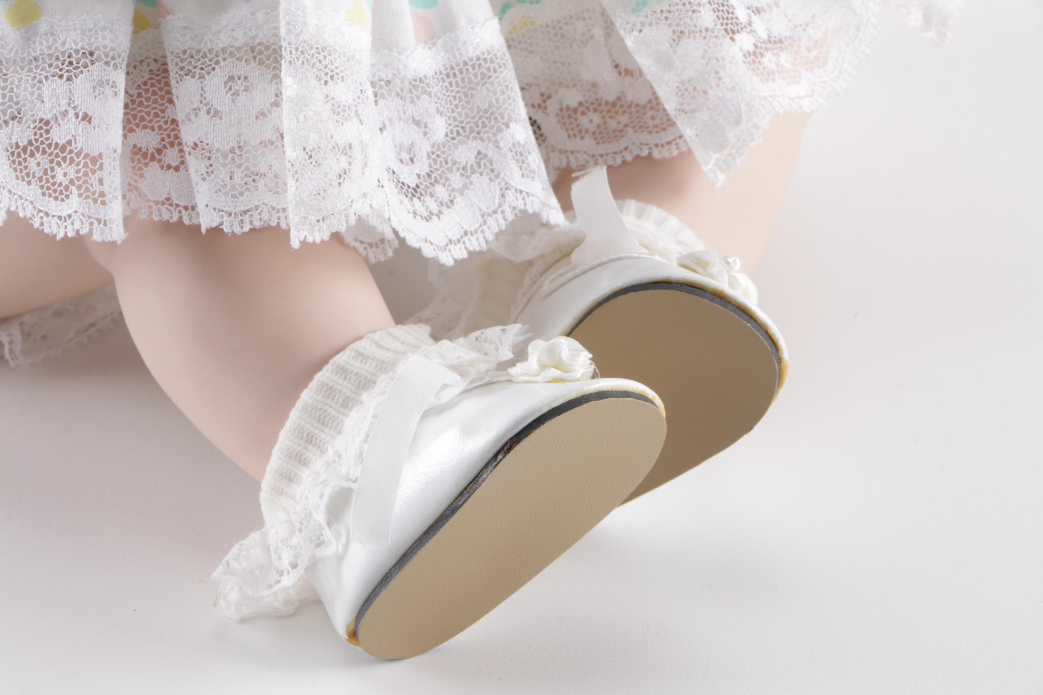 Porcelain Doll in Wicker Bassinet