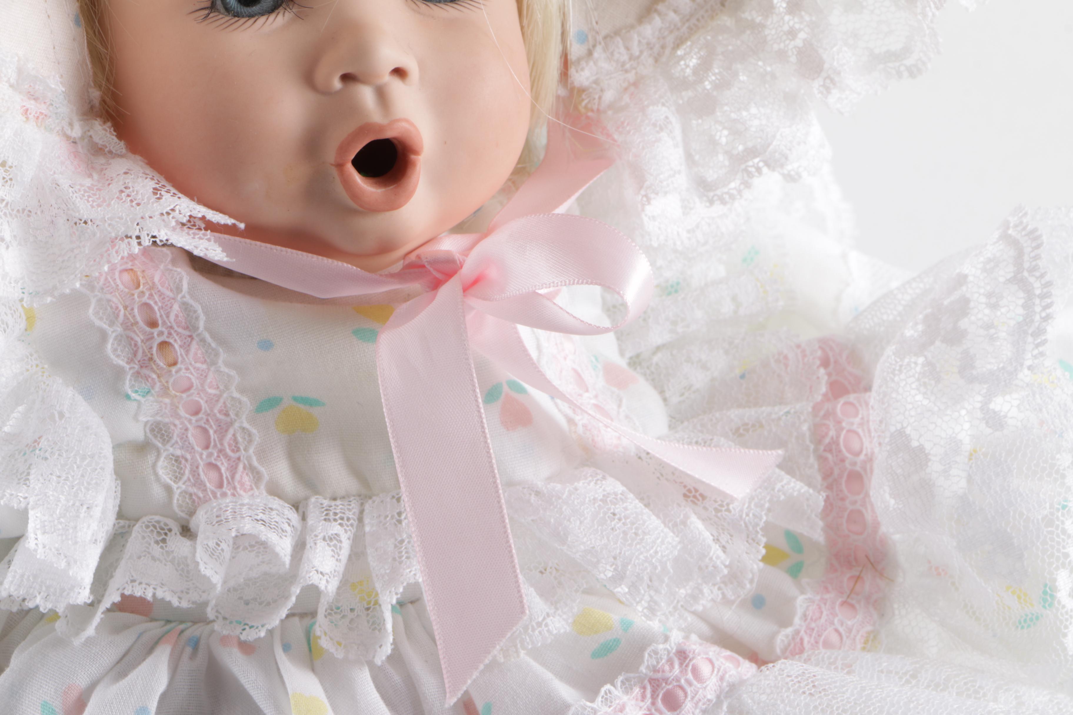 Porcelain Doll in Wicker Bassinet