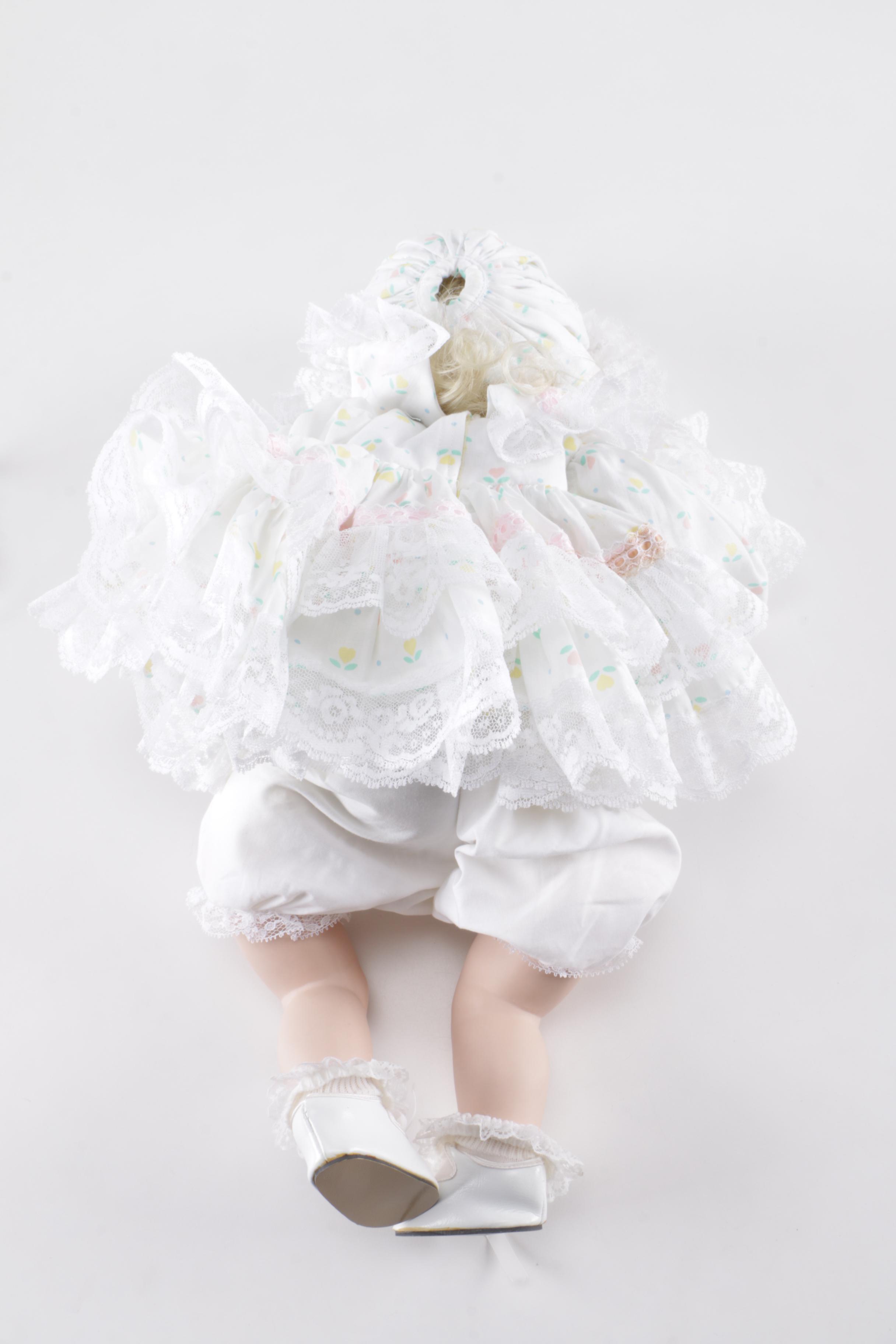 Porcelain Doll in Wicker Bassinet