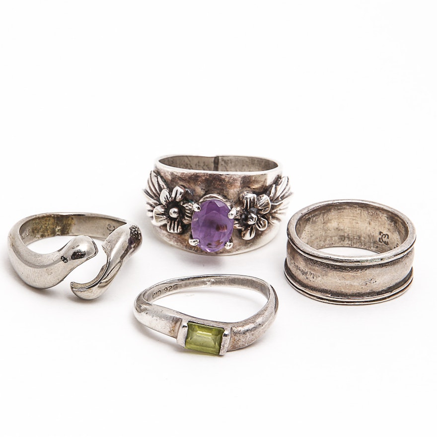 Four Sterling Rings Including Amethyst and Peridot