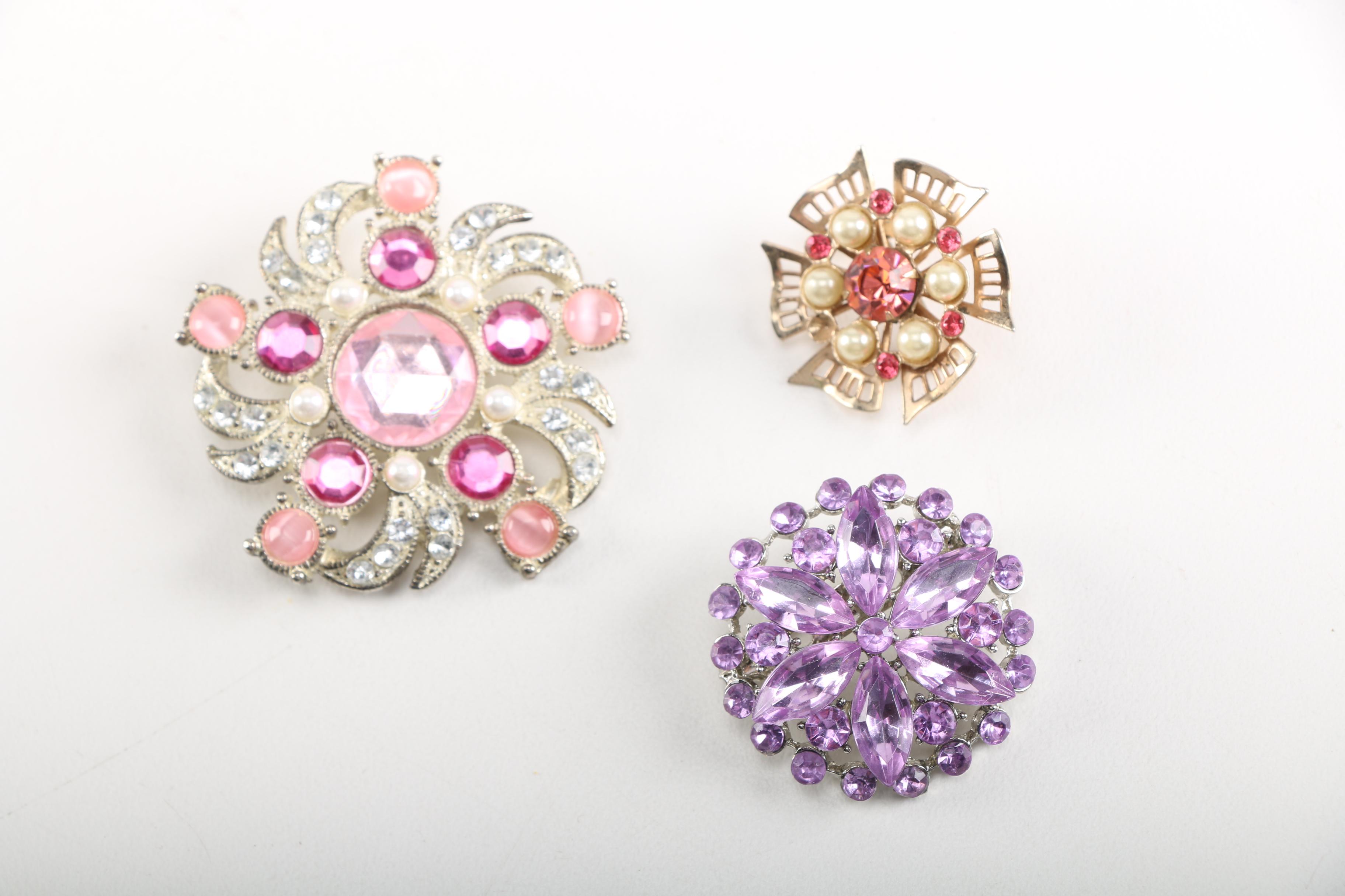 Assortment of Earrings Featuring a Pair Belt Buckles